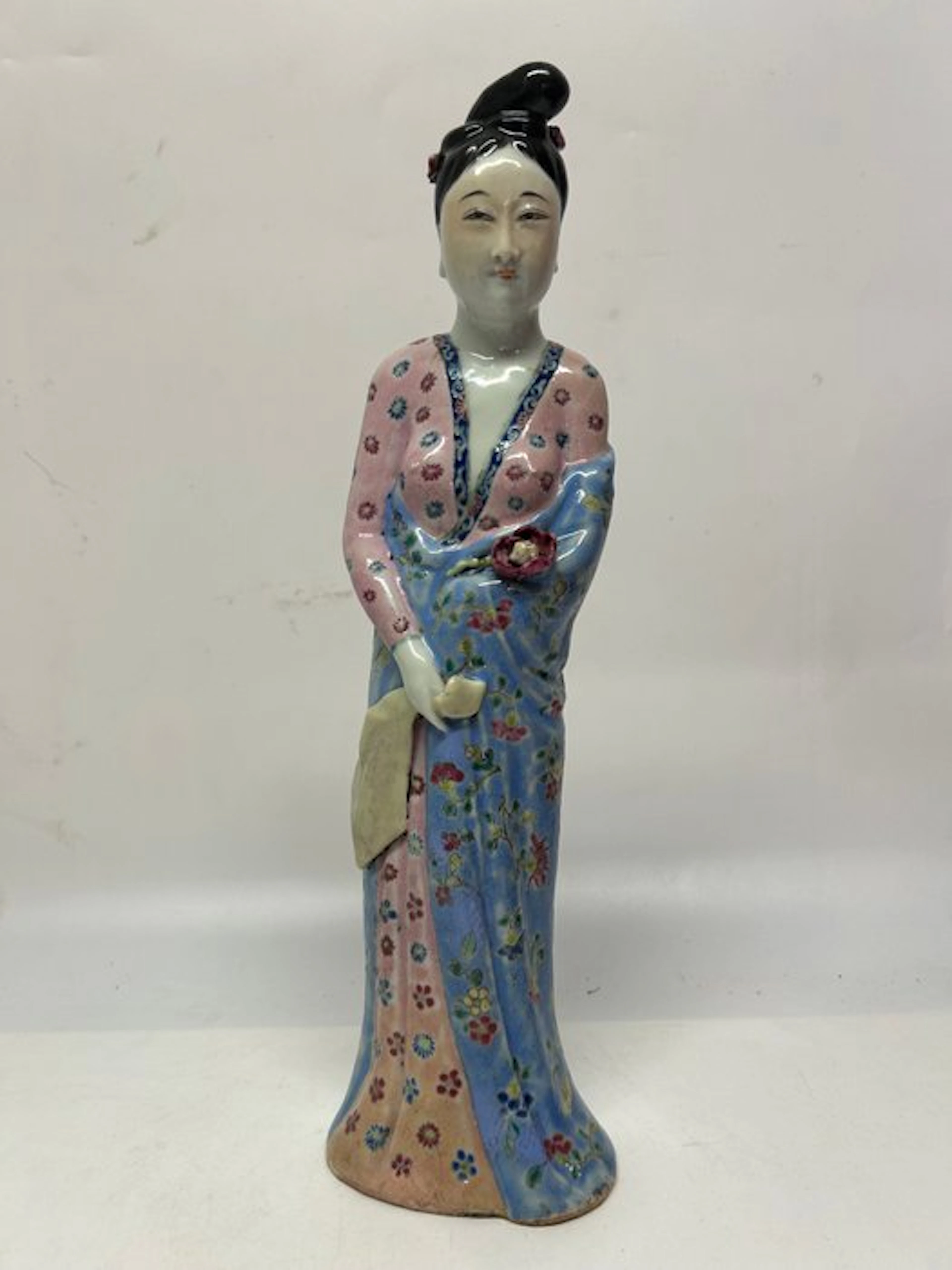 a refined sculpture of a Chinese lady in Famille Rose...