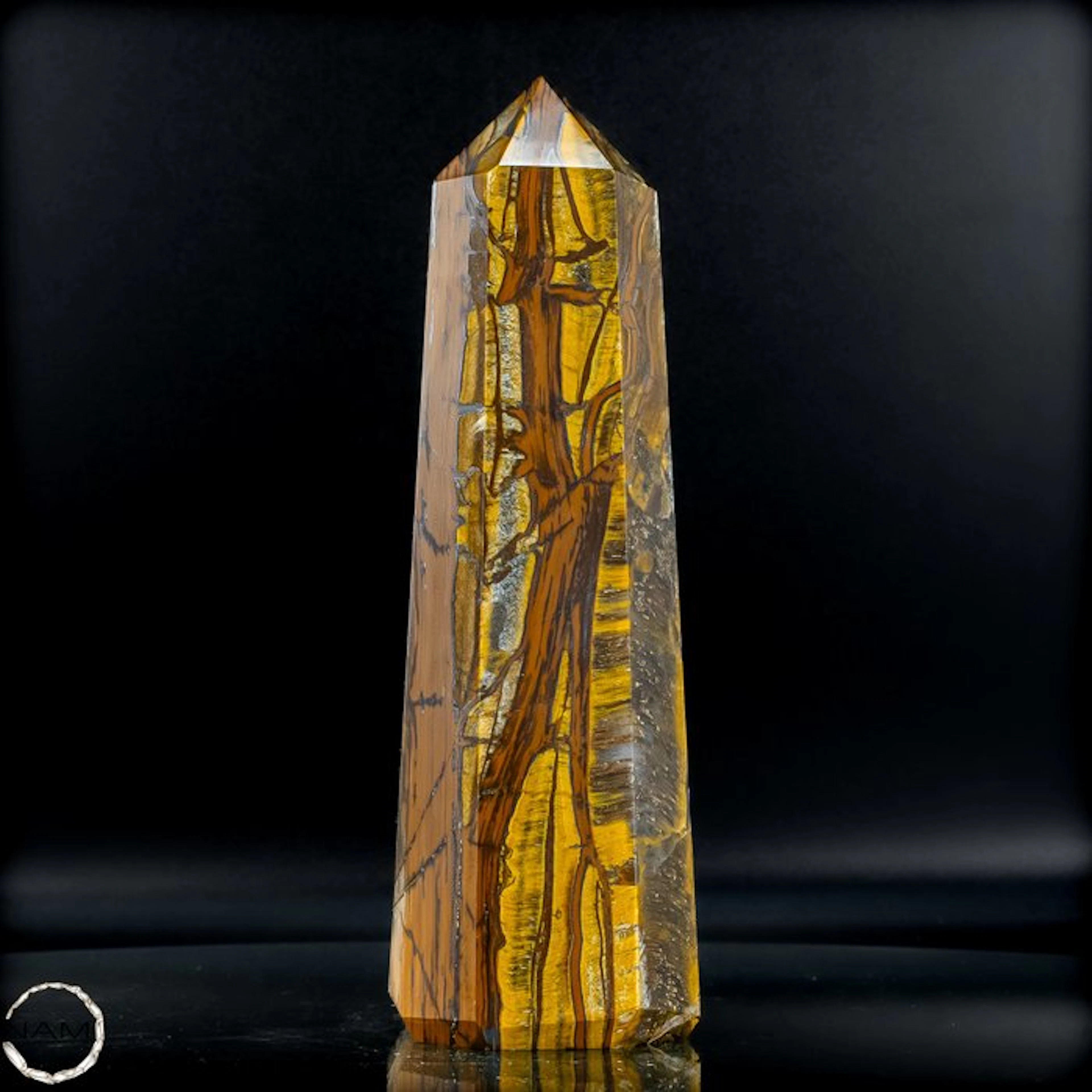 Natural tiger's-eye obelisk with a golden-brown silky texture.- 1226.31 g