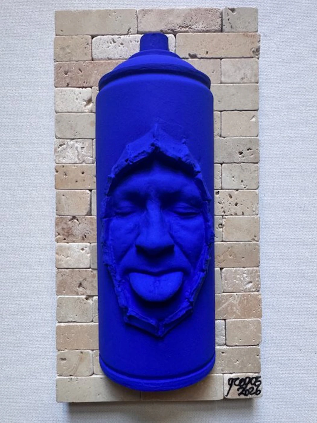 gregos - Blue mocking spray can on bricks