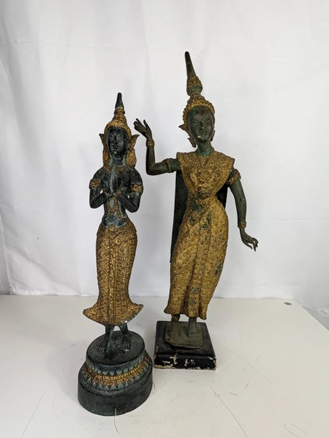 Bronze set – two Thai temple figures with gold staffage...
