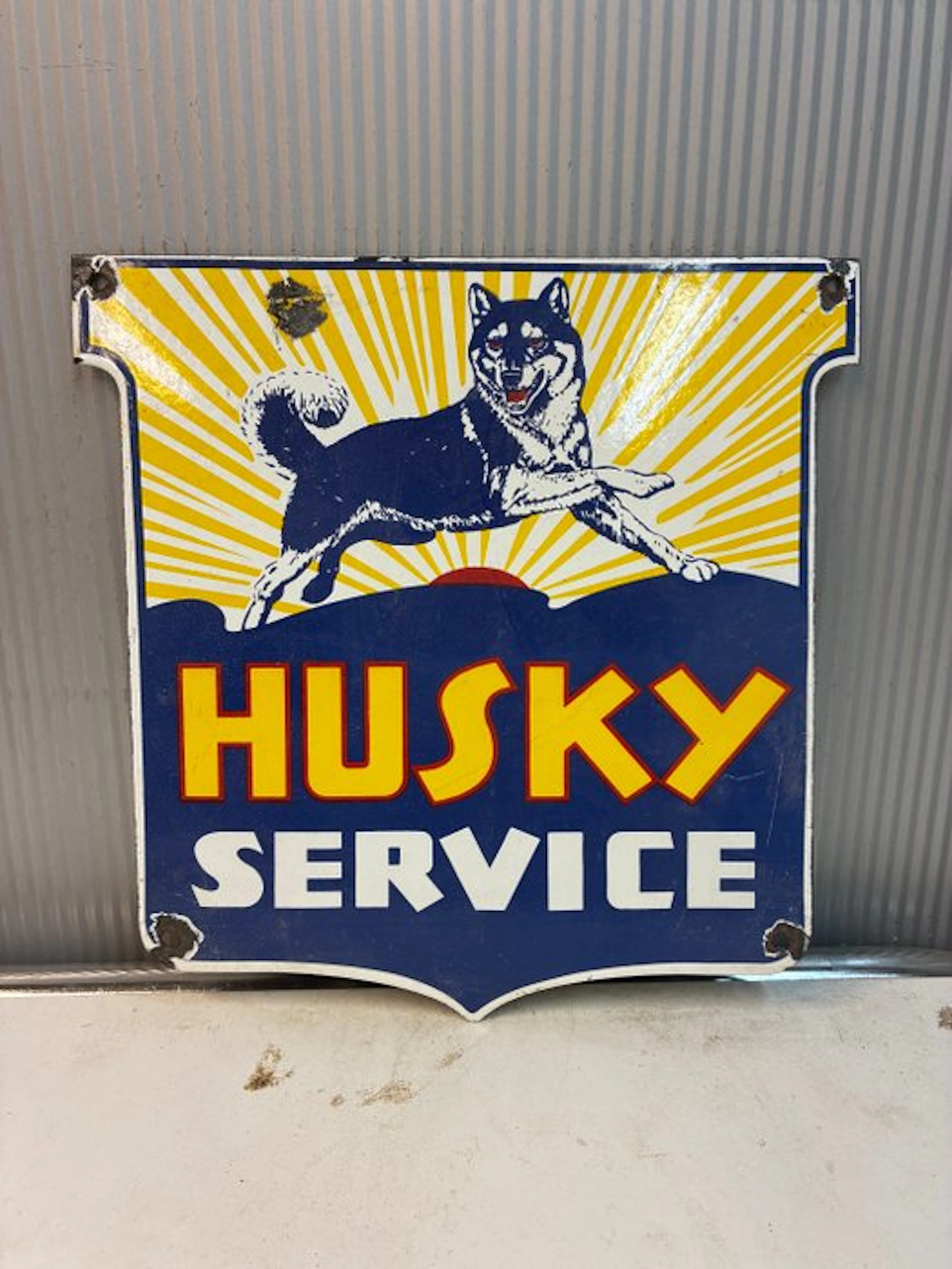 Husky Service – Decorative enamel advertising sign with a...