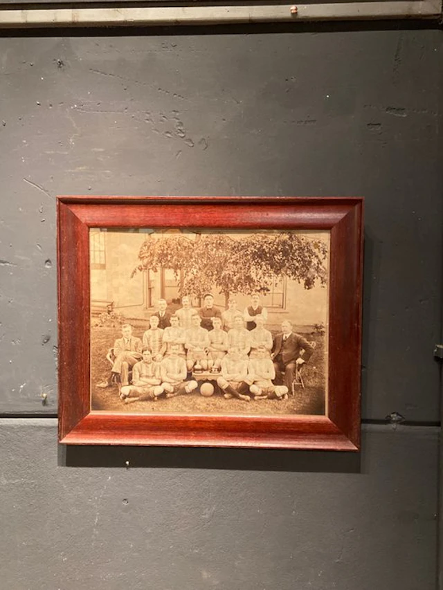 1910 - Antique photo of a soccer team in an old wooden frame.