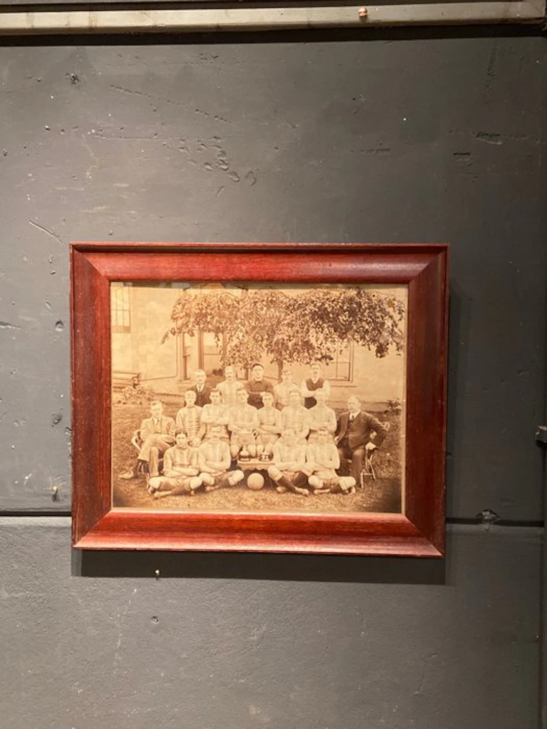 1910 - Antique photo of a soccer team in an old wooden frame.