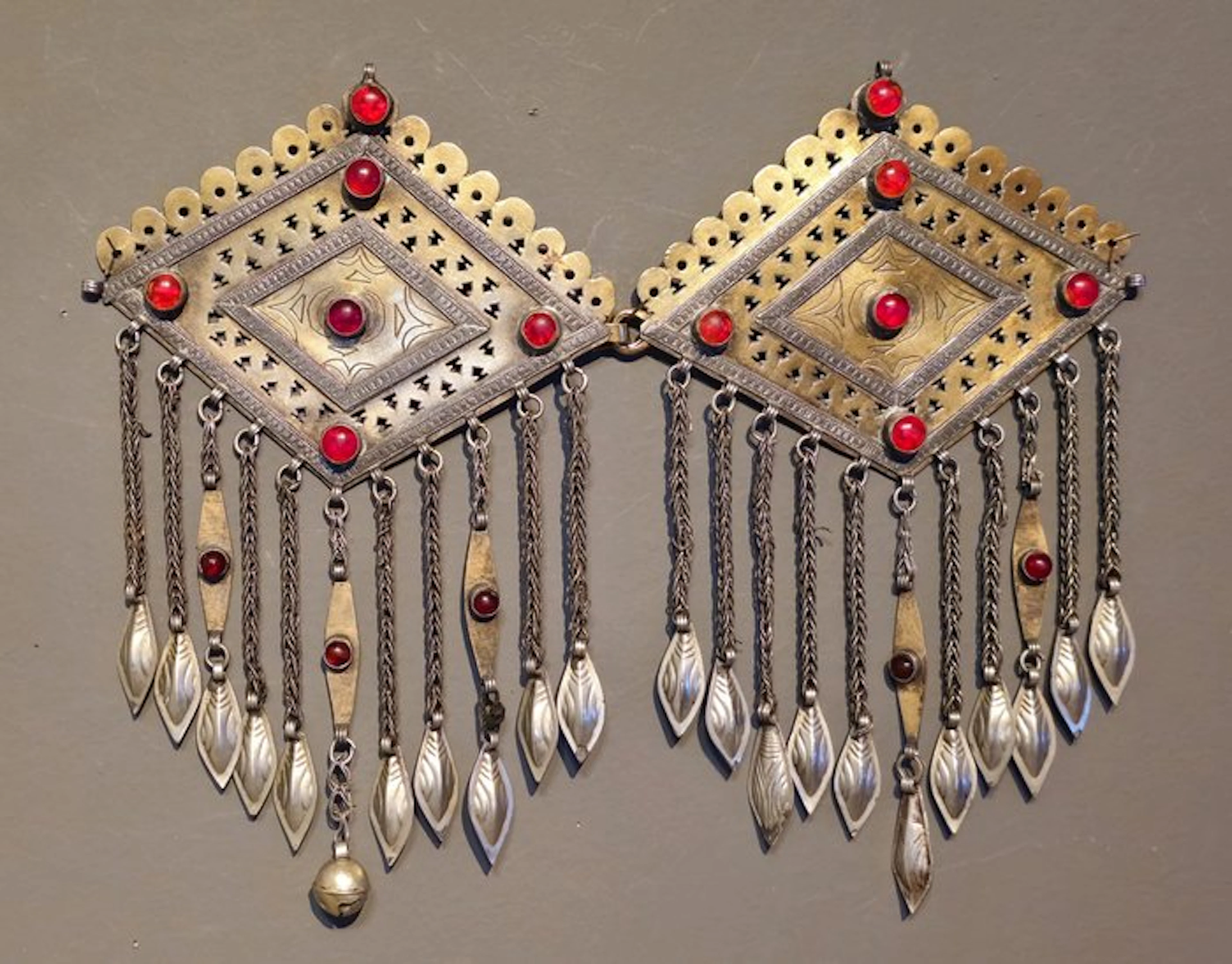 A pair of Turkmen fire gilded silver tunic decorations...