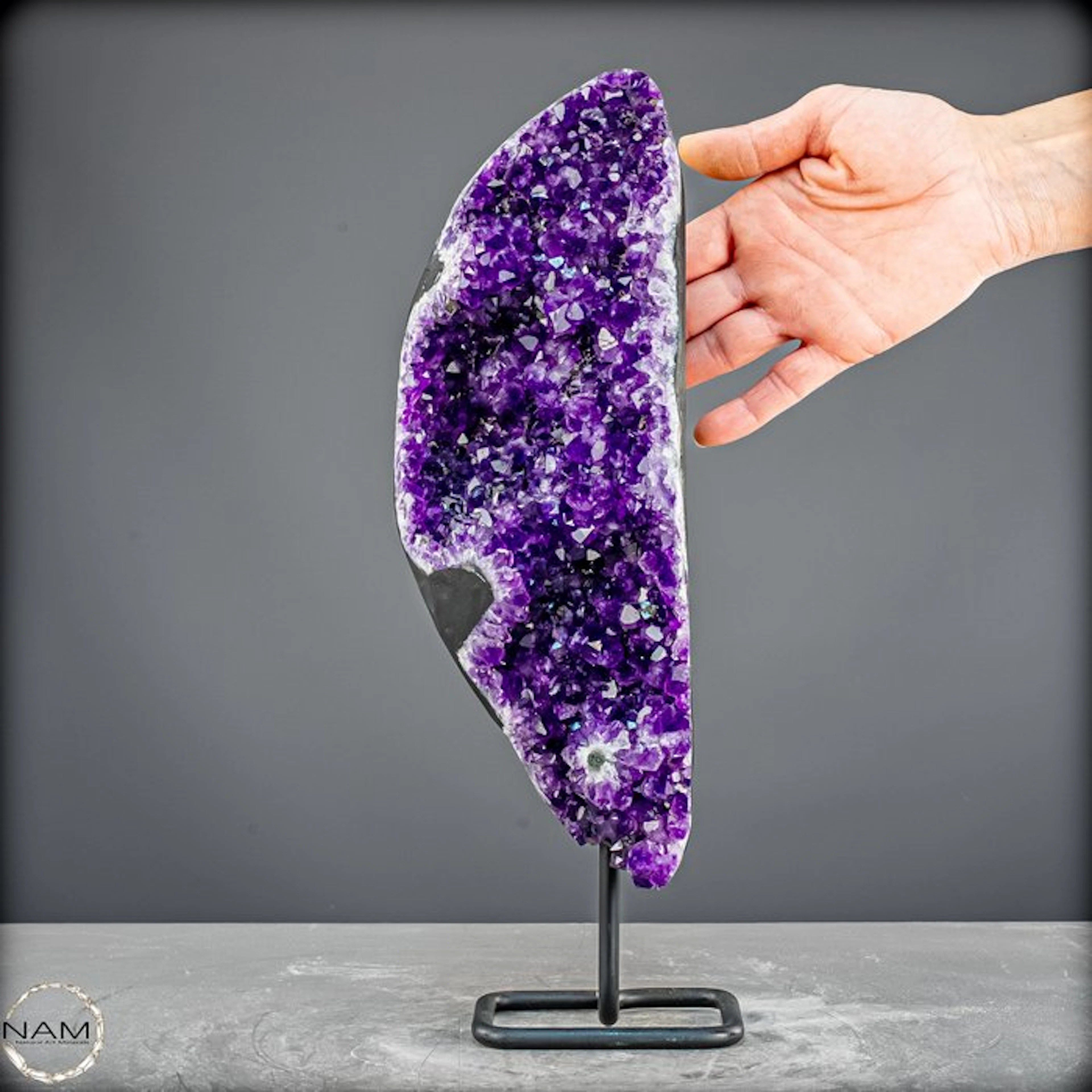 Radiant amethyst on a metal stand – elegance in violet splendor