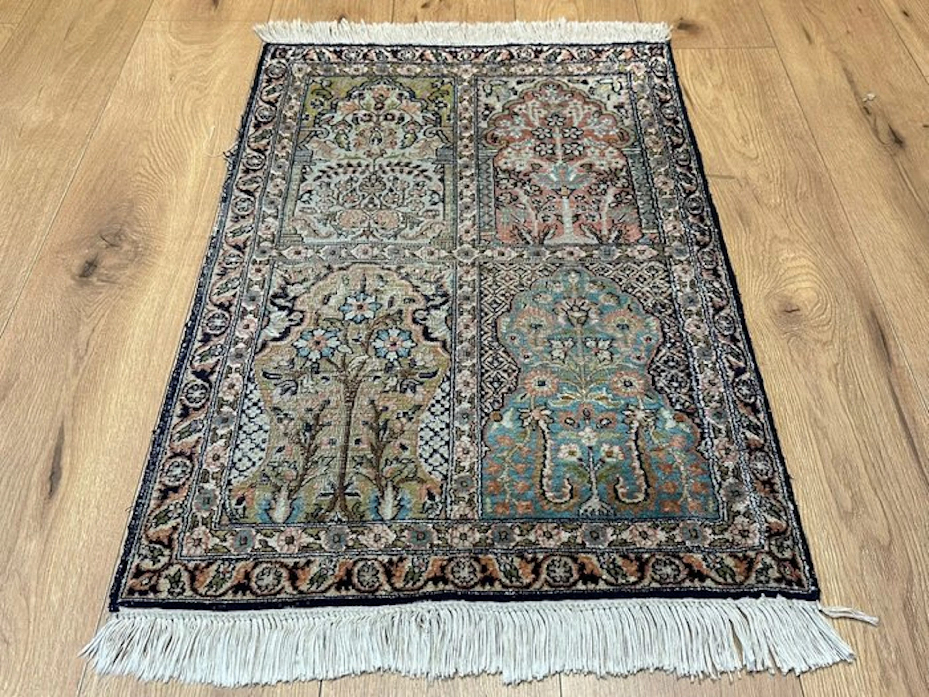 Exquisite Kashmiri silk rug with a delicate four-field...