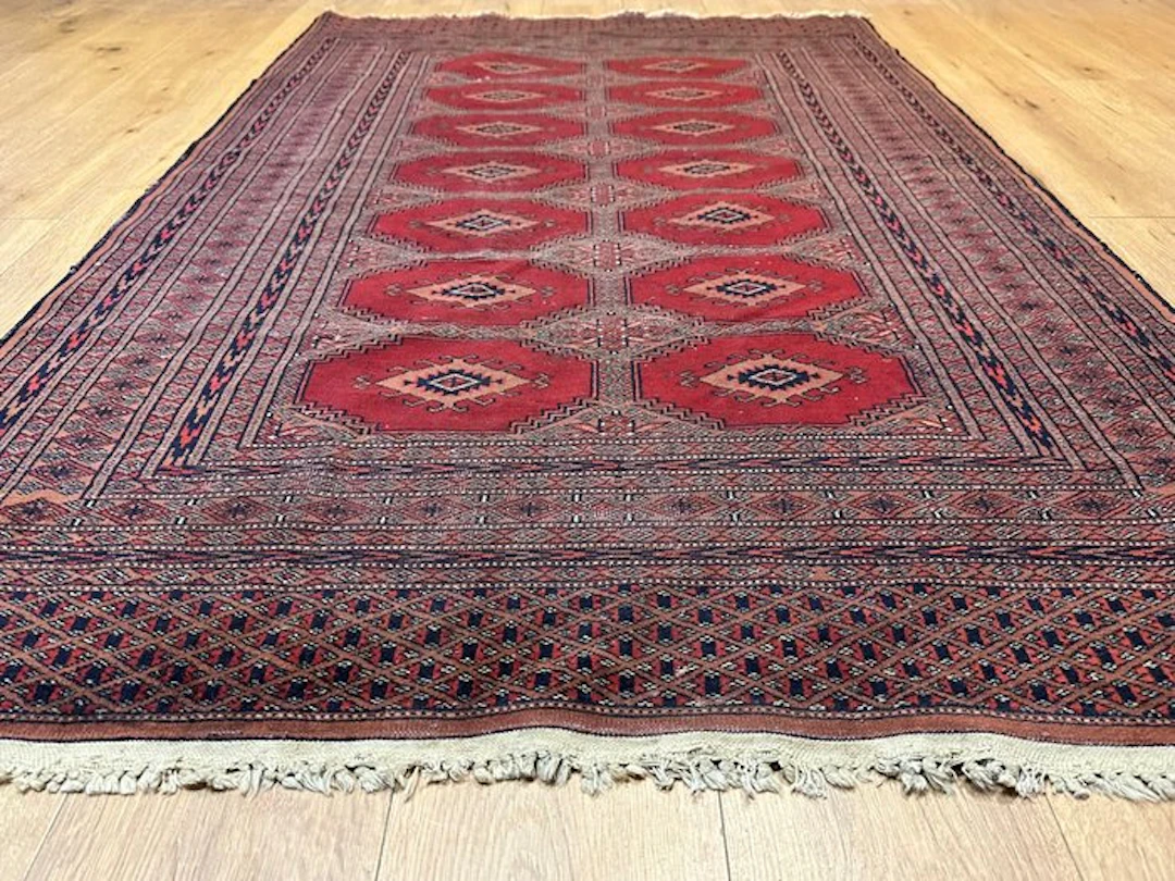Hand-knotted Pakistan Bokhara Oriental rug with a classic...