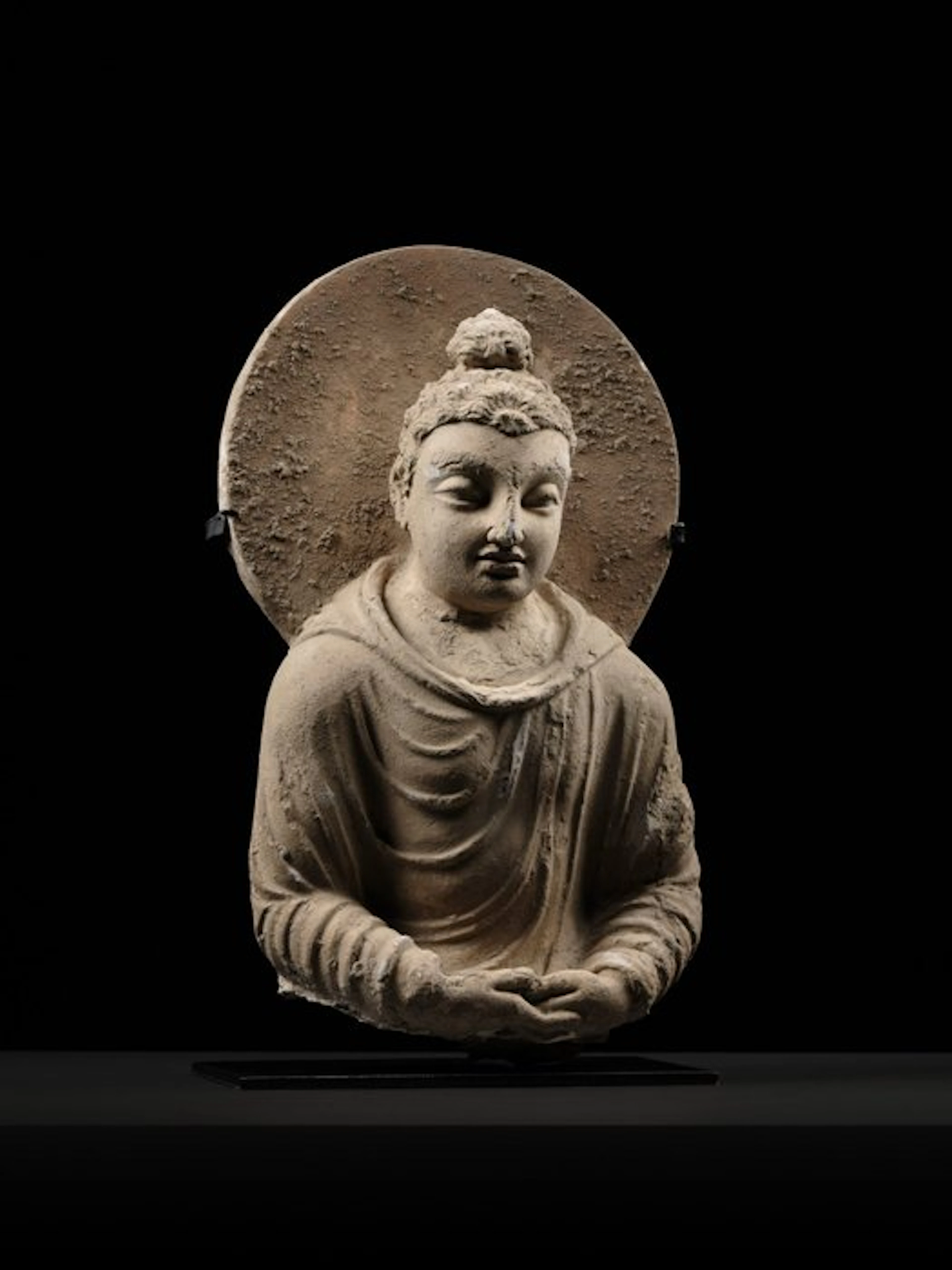 Gandhara Stucco Bust of Shakyamuni Buddha in stucco with a large circular