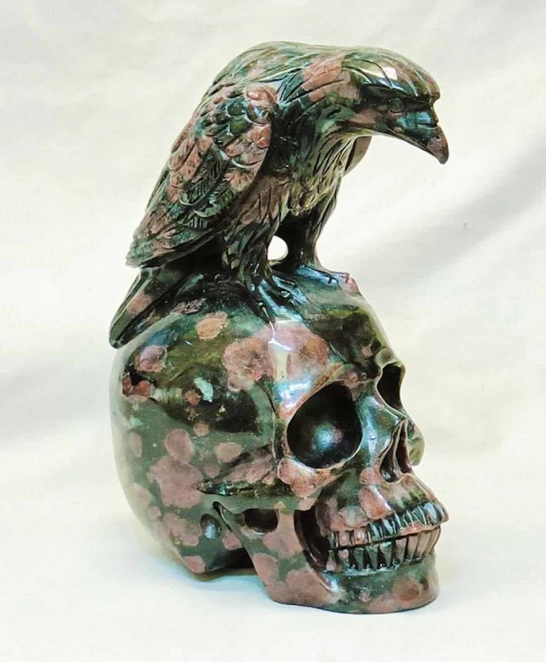 Raven sculpture on a human skull