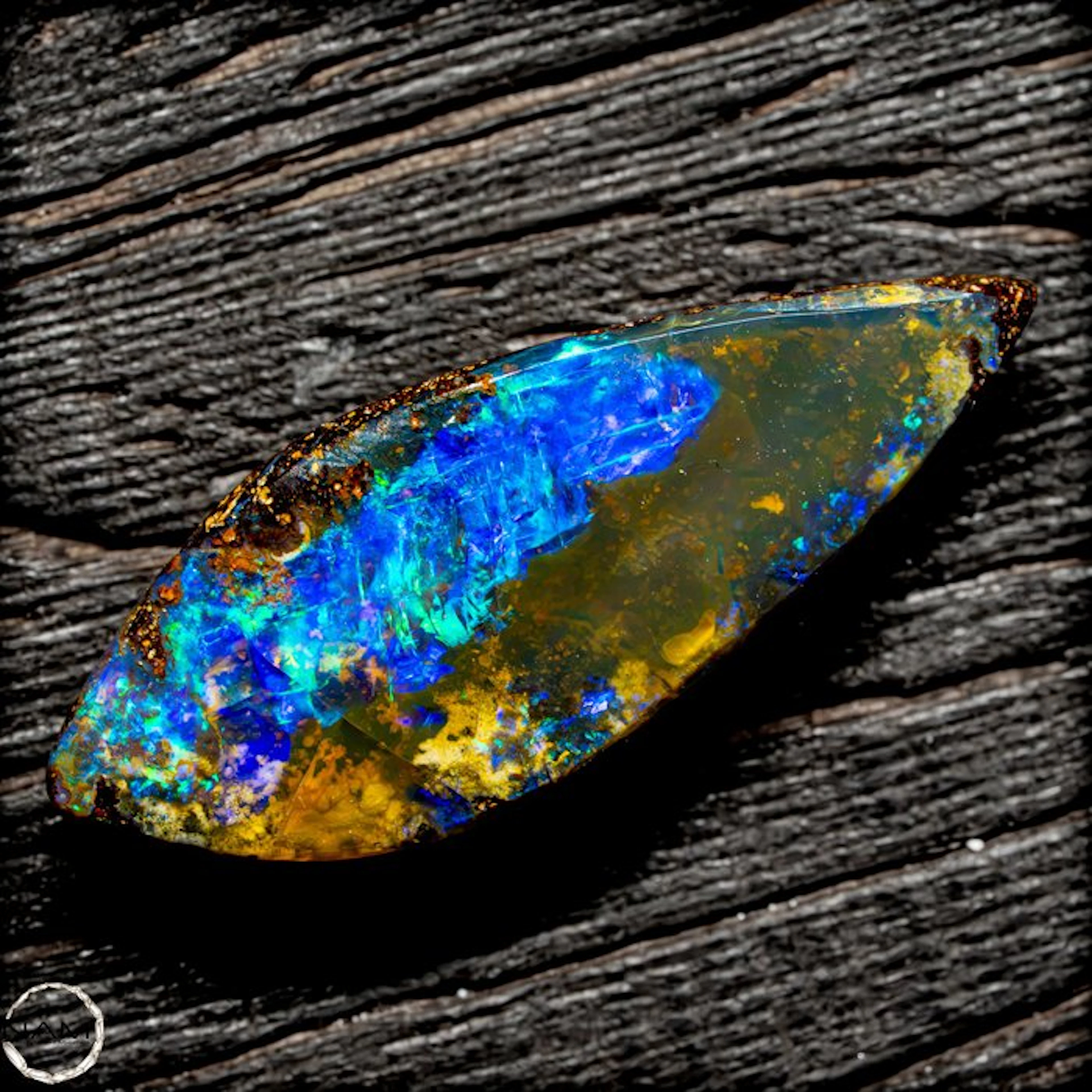 Australian Boulder Opal cabochon with an intense multicolored play of color