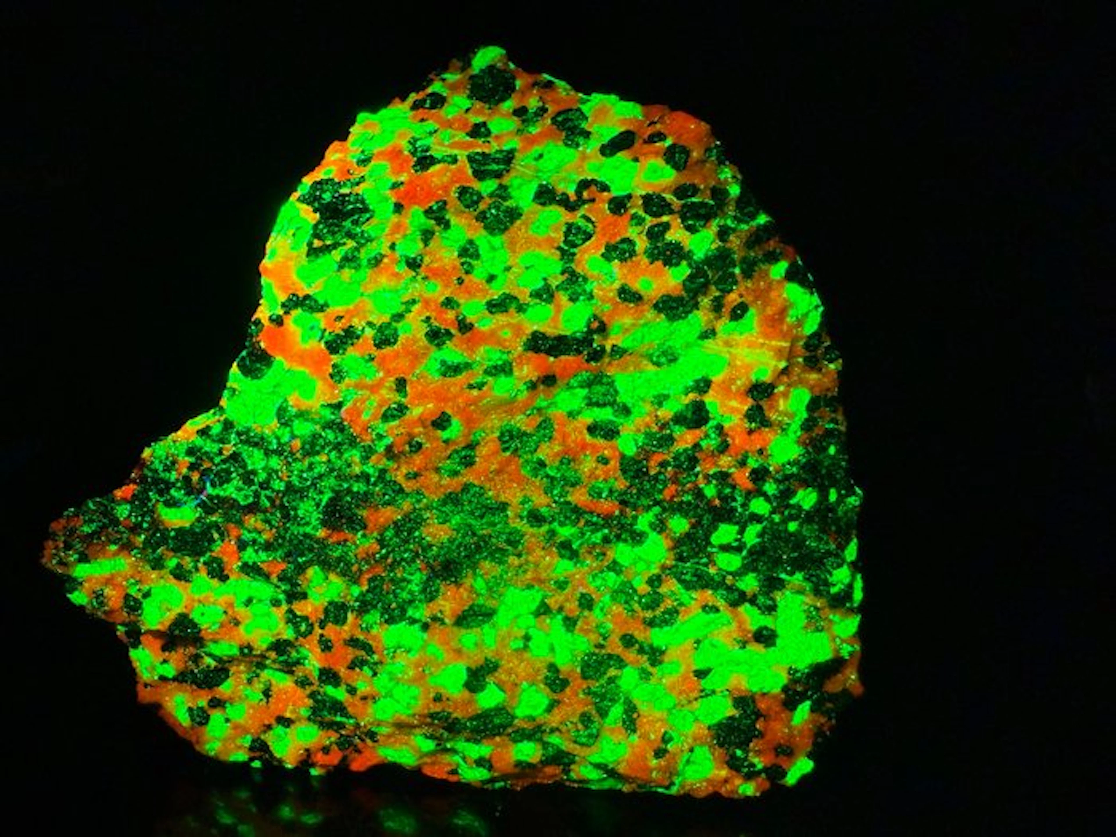 Extremely bright willemite and calcite with zincite vein...