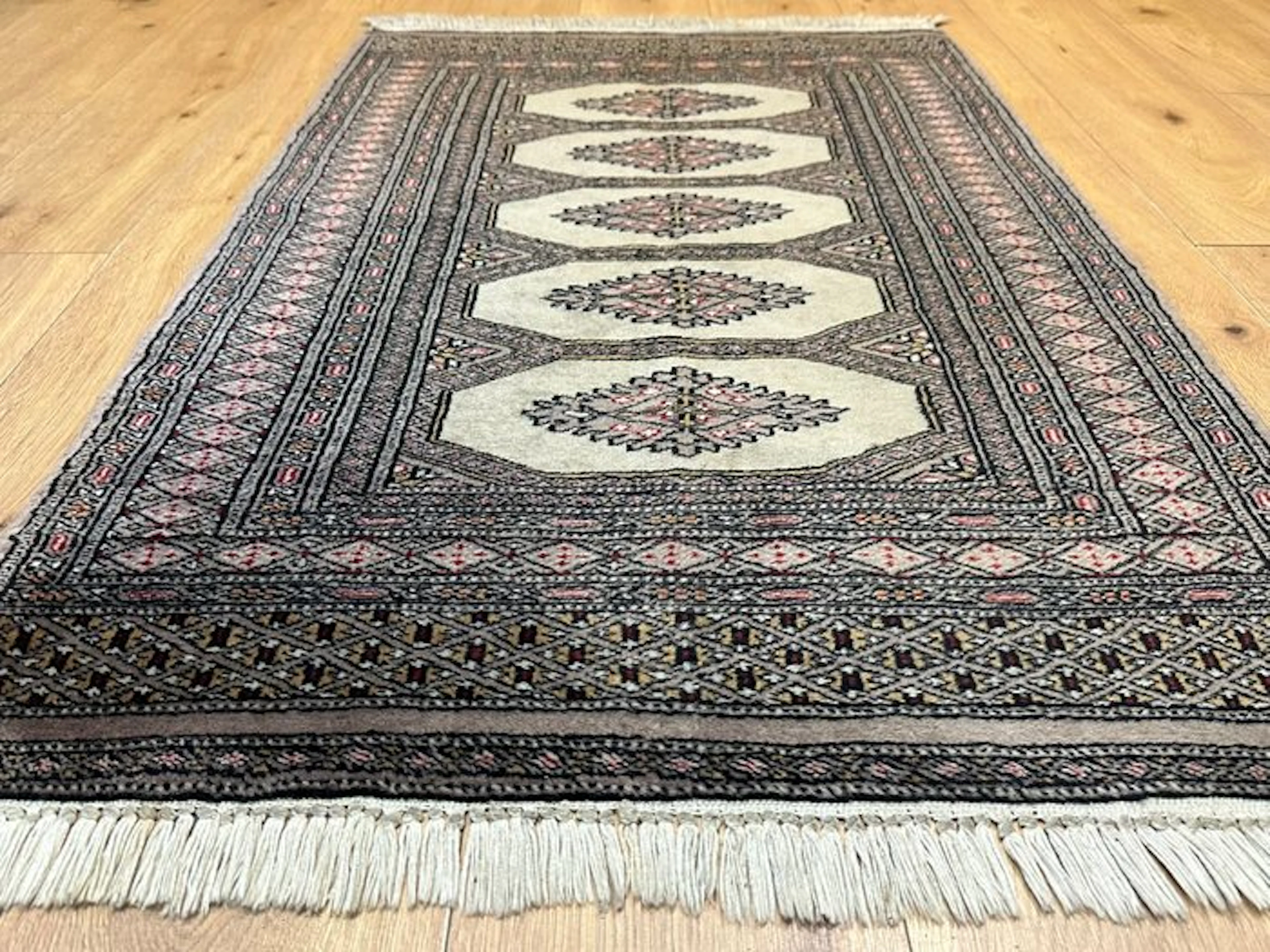 Hand-knotted Pakistan Bokhara Oriental rug with a classic...