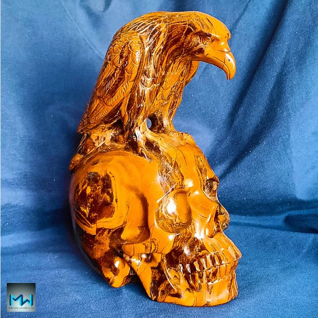 Crow sculpture atop a human skull