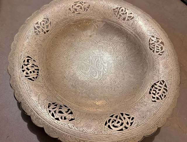 Plate with Arabic calligraphy in open work and engraved...