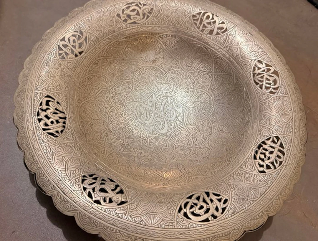 Plate with Arabic calligraphy in open work and engraved...