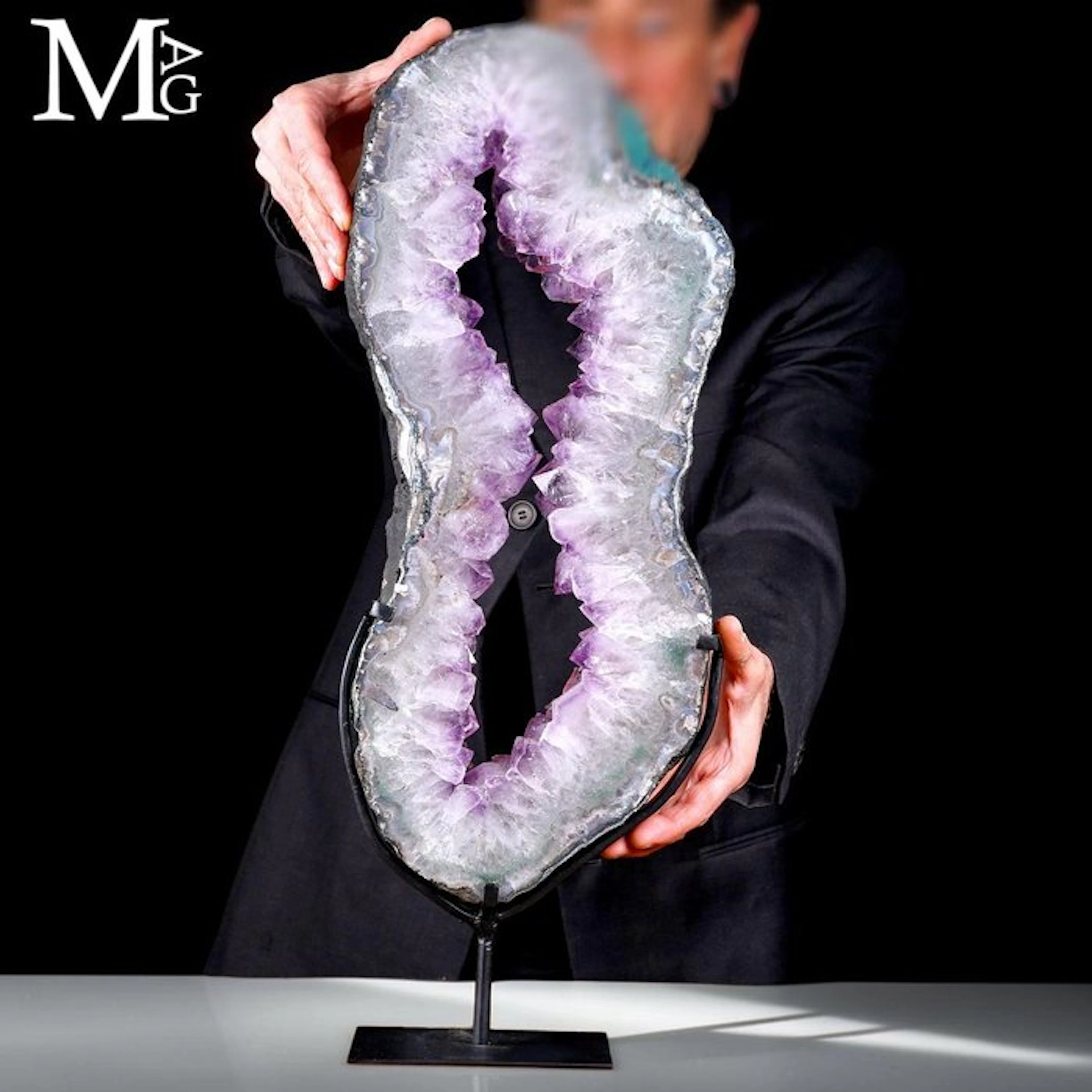 Large slice of Brazilian amethyst geode on a stand...