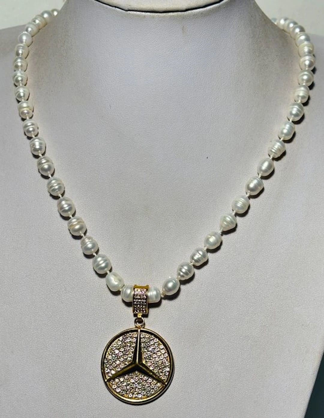 Natural freshwater White Baroque pearls with a 'Mercedes' pendant
