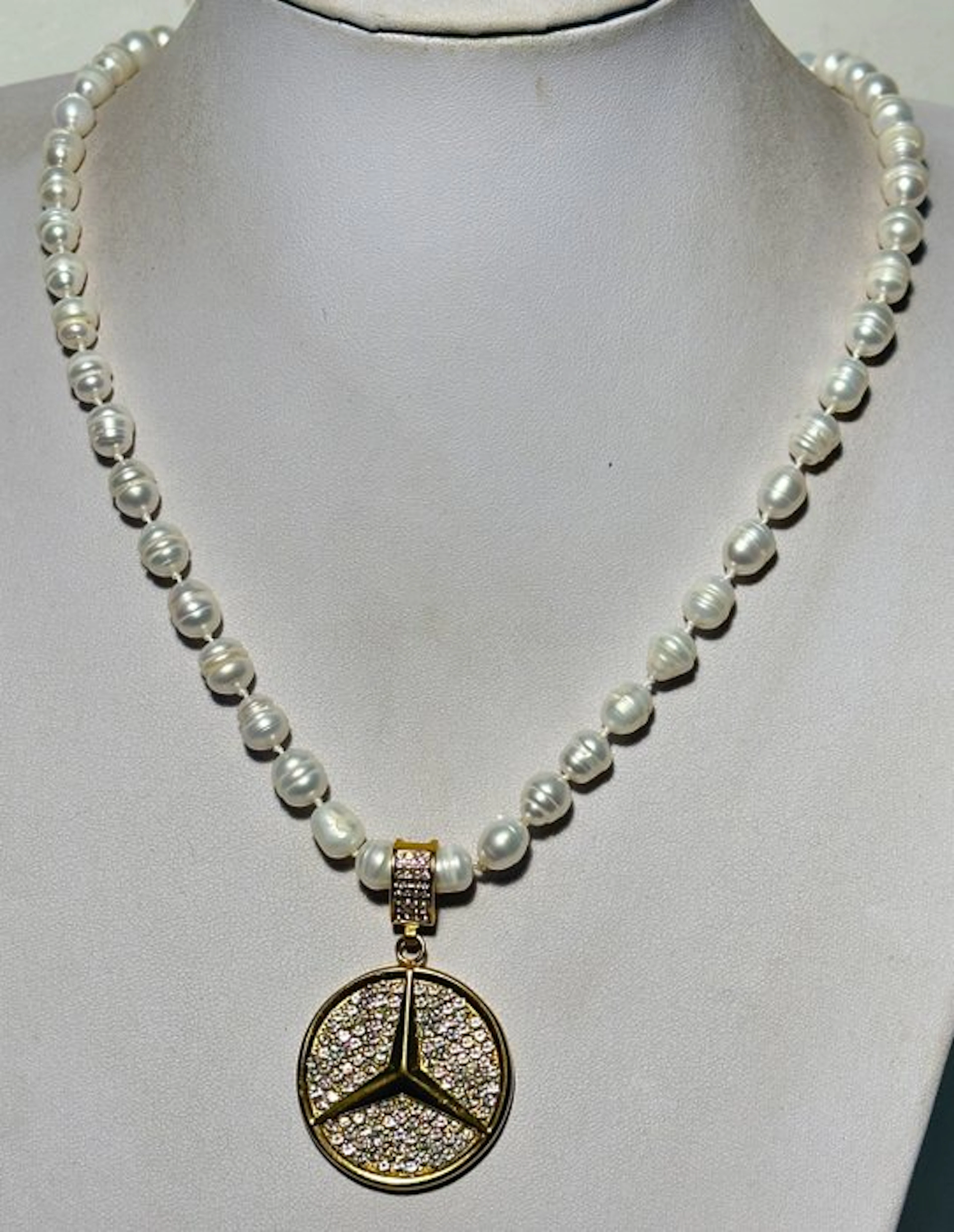 Natural freshwater White Baroque pearls with a 'Mercedes' pendant