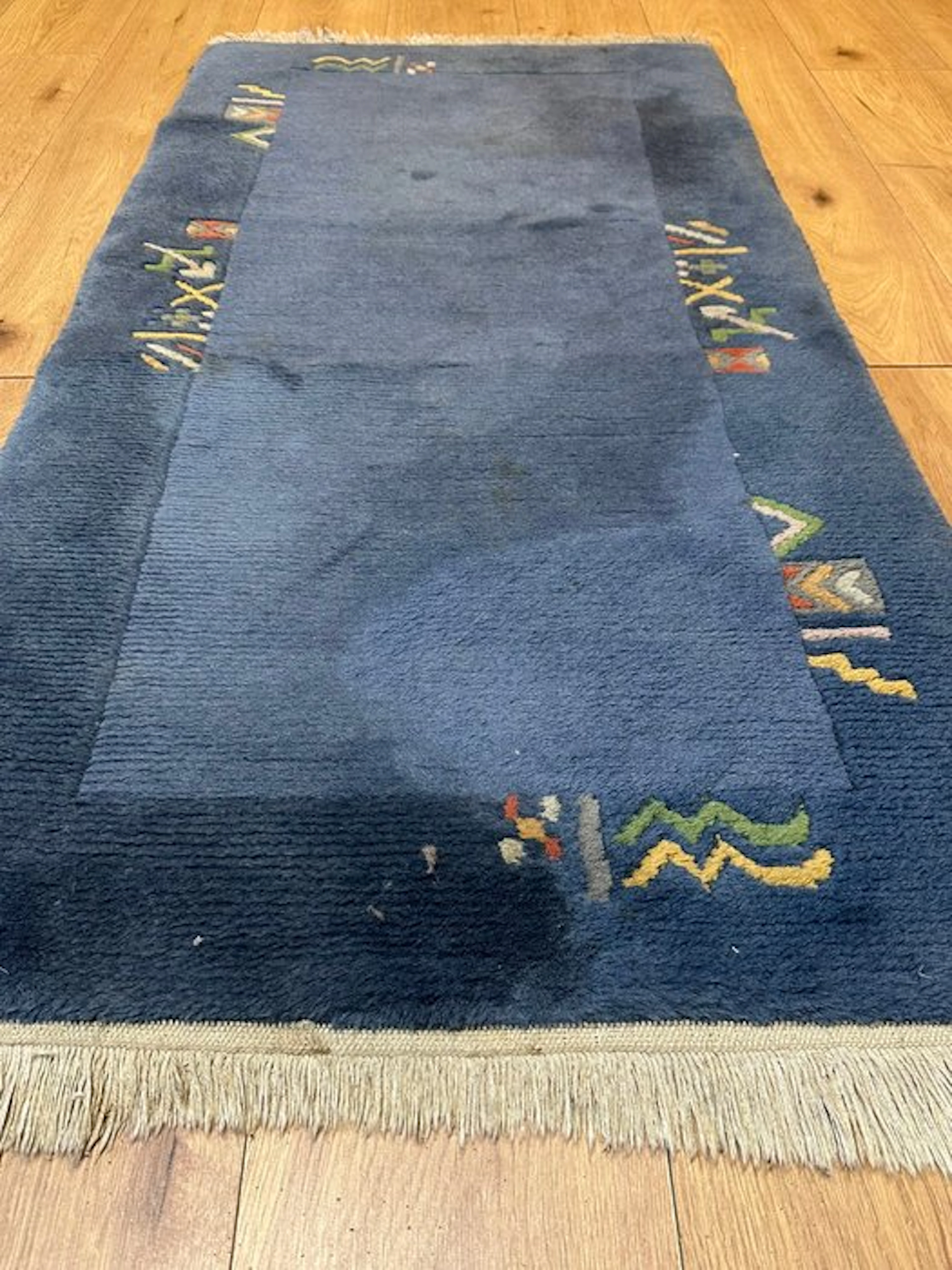 Beautiful hand-knotted Nepal rug in elegant blue with traditional accents