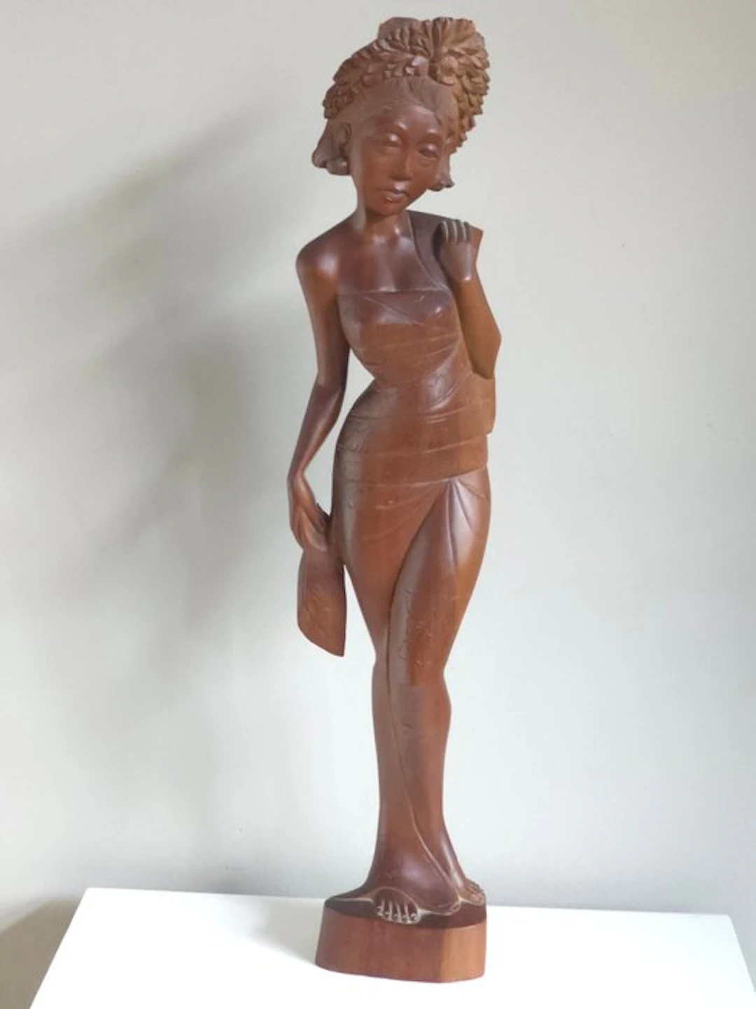 Large Balinese wood carving of a young woman in a sarong...