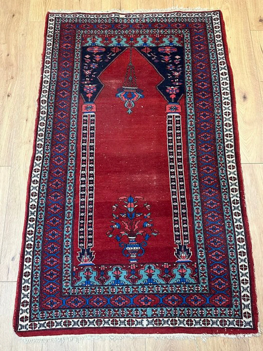 Hand-knotted Oriental rug with a mihrab and floral...