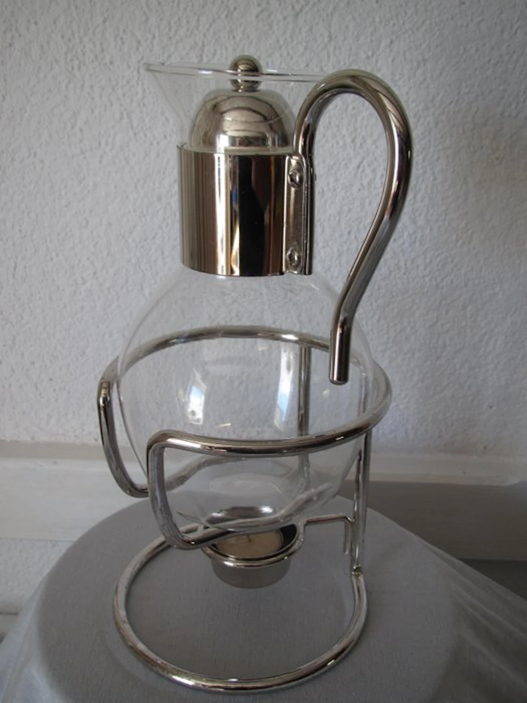 Can - a beautiful glass pitcher in a silver-plated frame