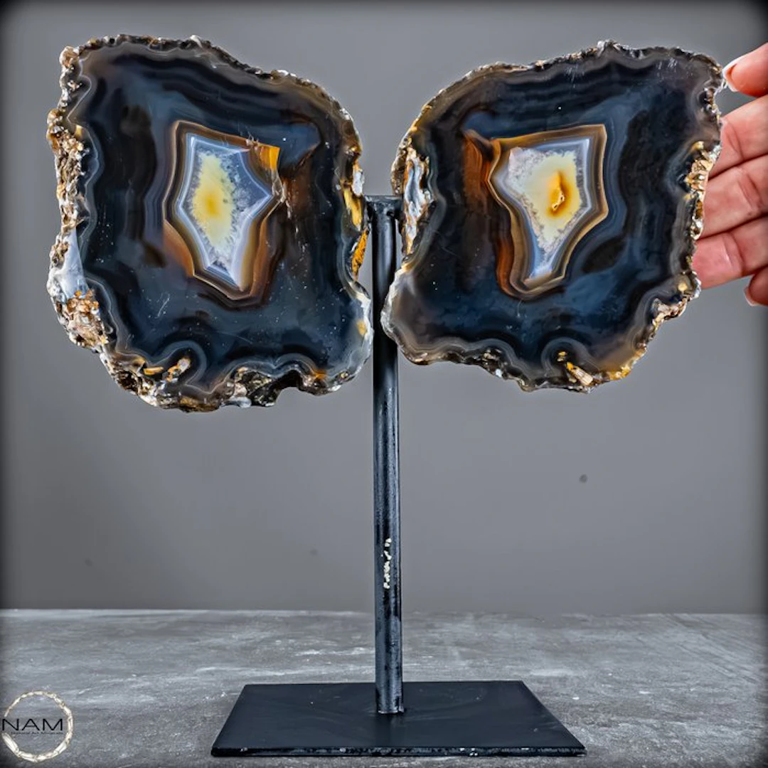 Agate druzy wings on a metal stand – a symmetrical...