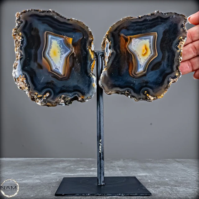 Agate druzy wings on a metal stand – a symmetrical...