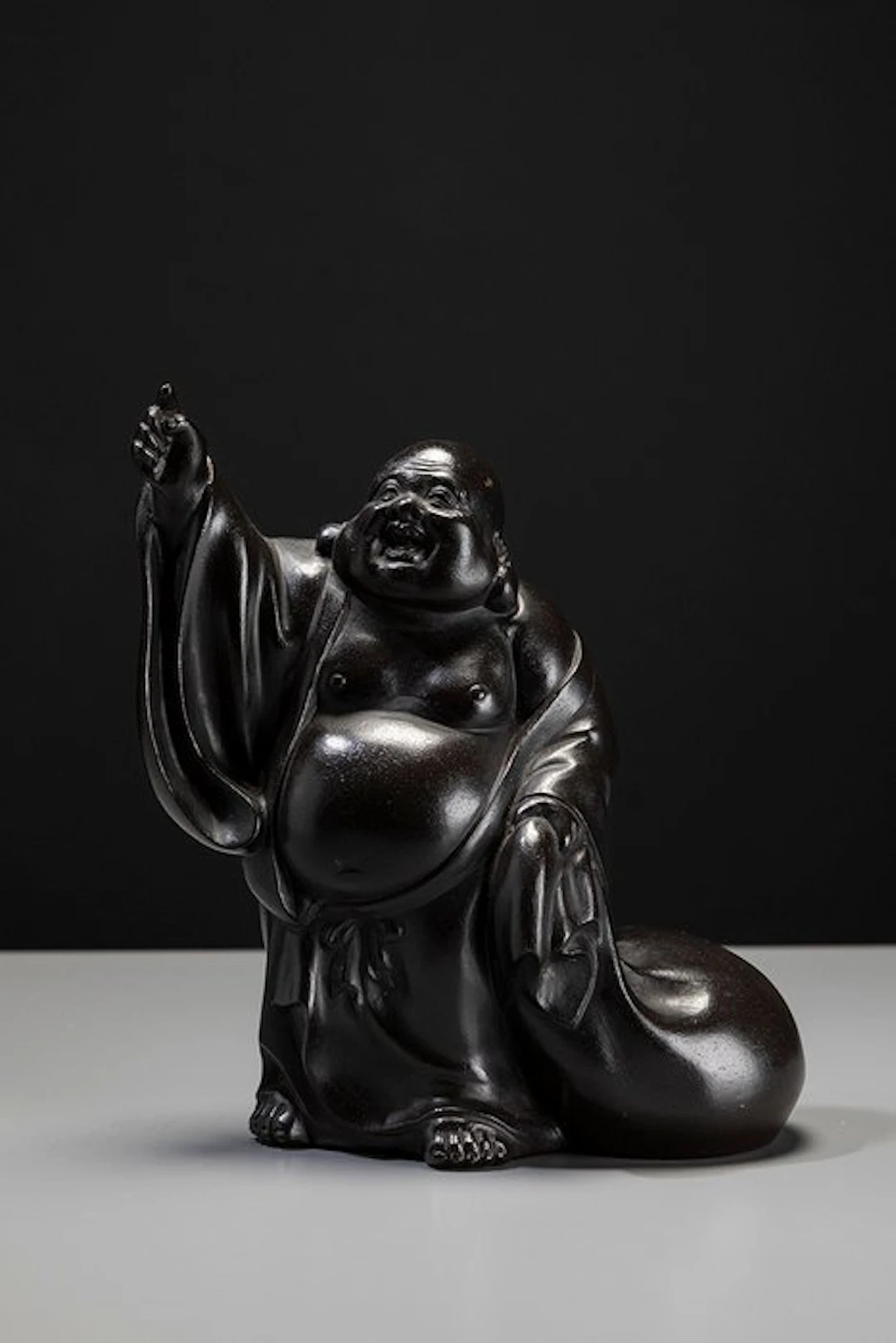 Bronze - A bronze okimono depicting a smiling Hotei...