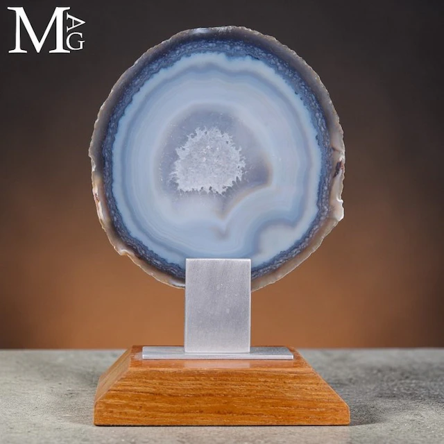 Polished geode slice with a central cavity of sparkling...