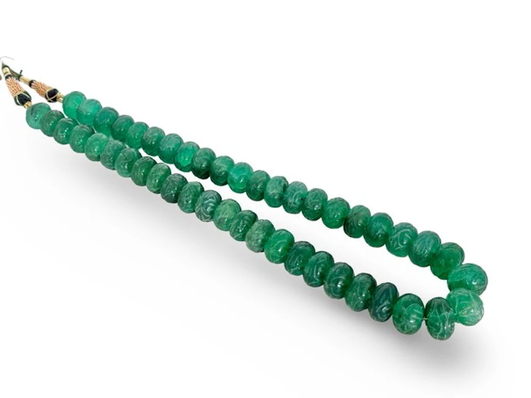 Approximately 46 handmade emerald-colored quartz beads from India.- 160 g
