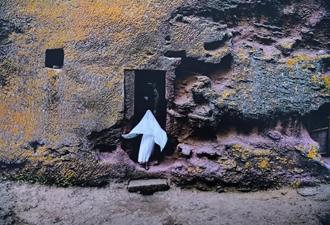Steve McCurry (1950–) - Woman entering a rock-hewn church in Lalibela
