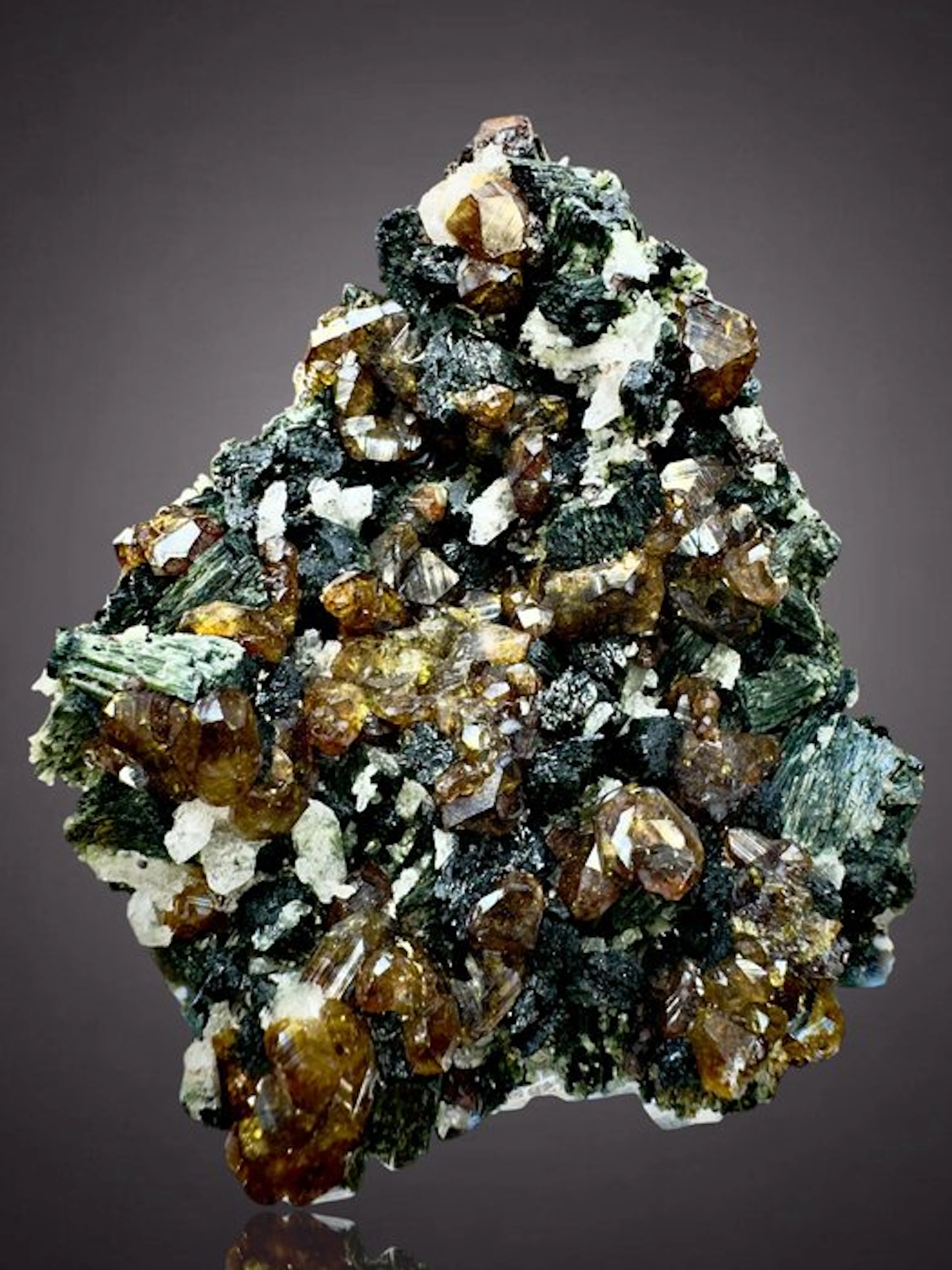 High-quality topaziolite on Hedembergite and Quartz...