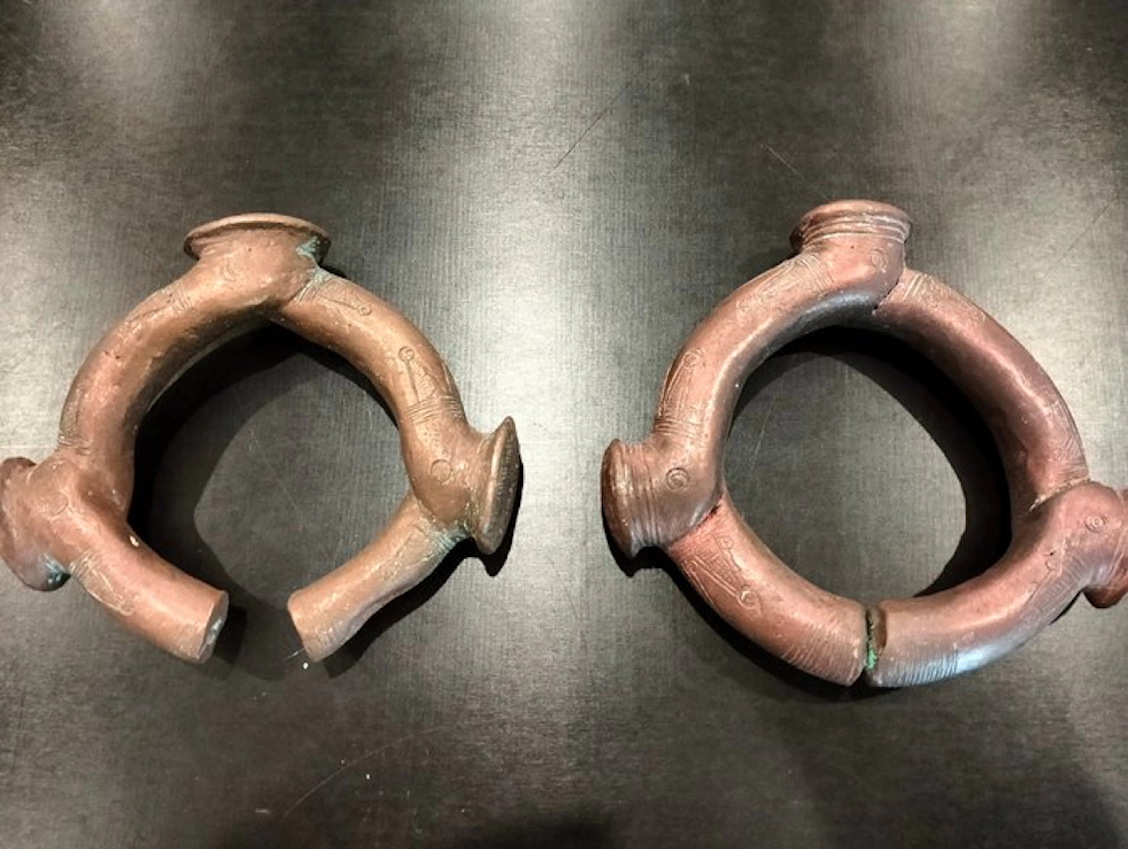A superb pair of coin bracelets with prongs in bronze