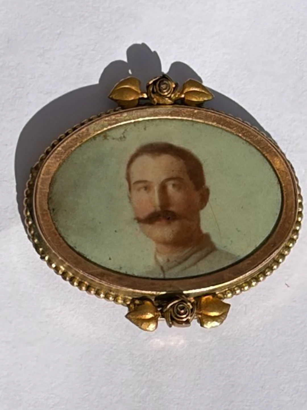 Antique photo locket pendant in low-karat Bourbon gold or laminated