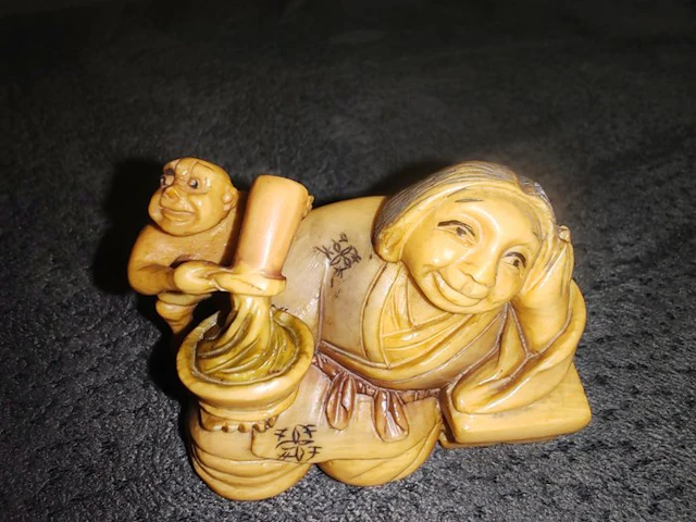 Japan – Netsuke in finely carved bone – Okame with...
