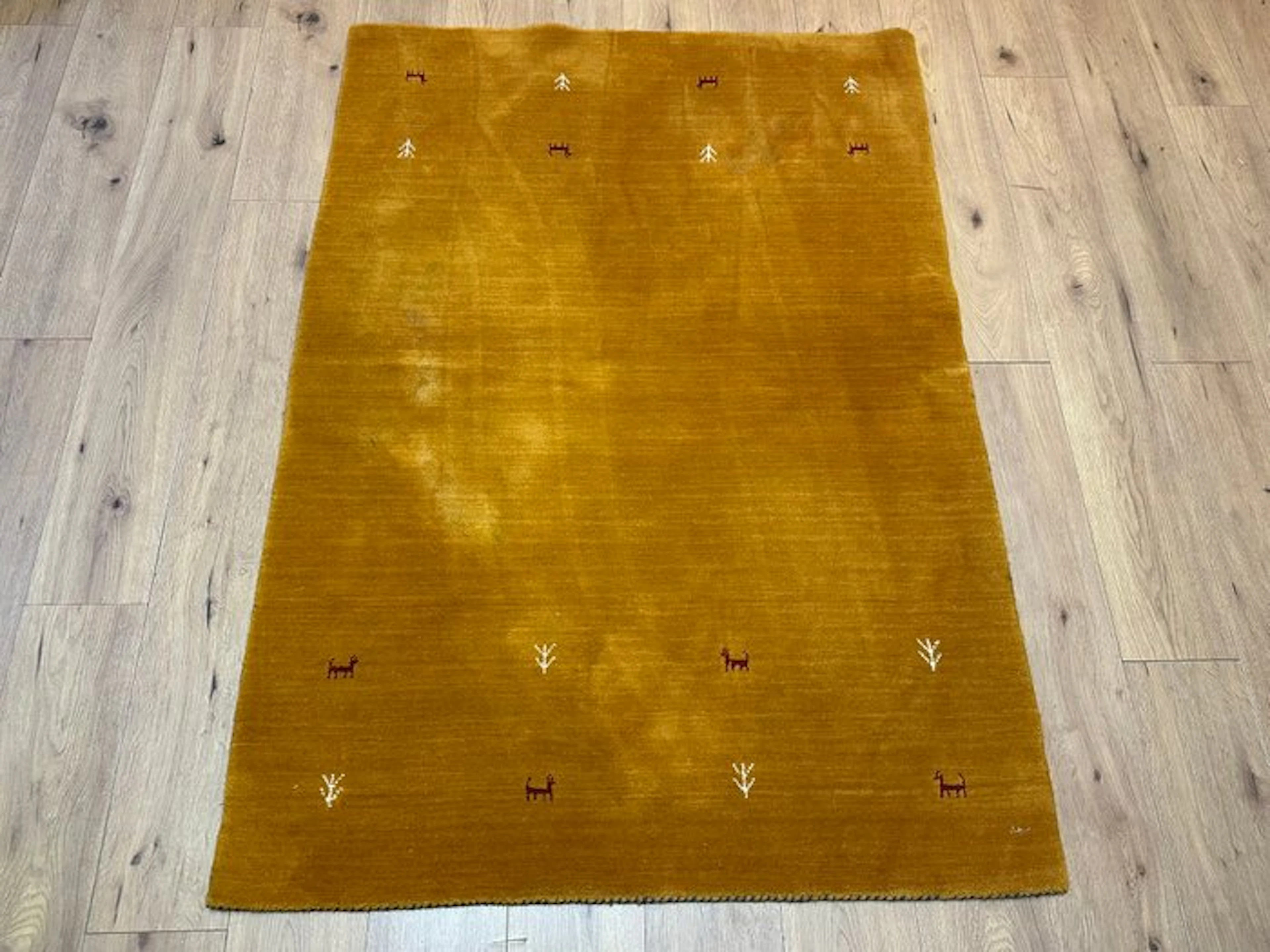 Sunny mustard yellow: a finely hand-knotted Gabbeh rug with nomadic motifs