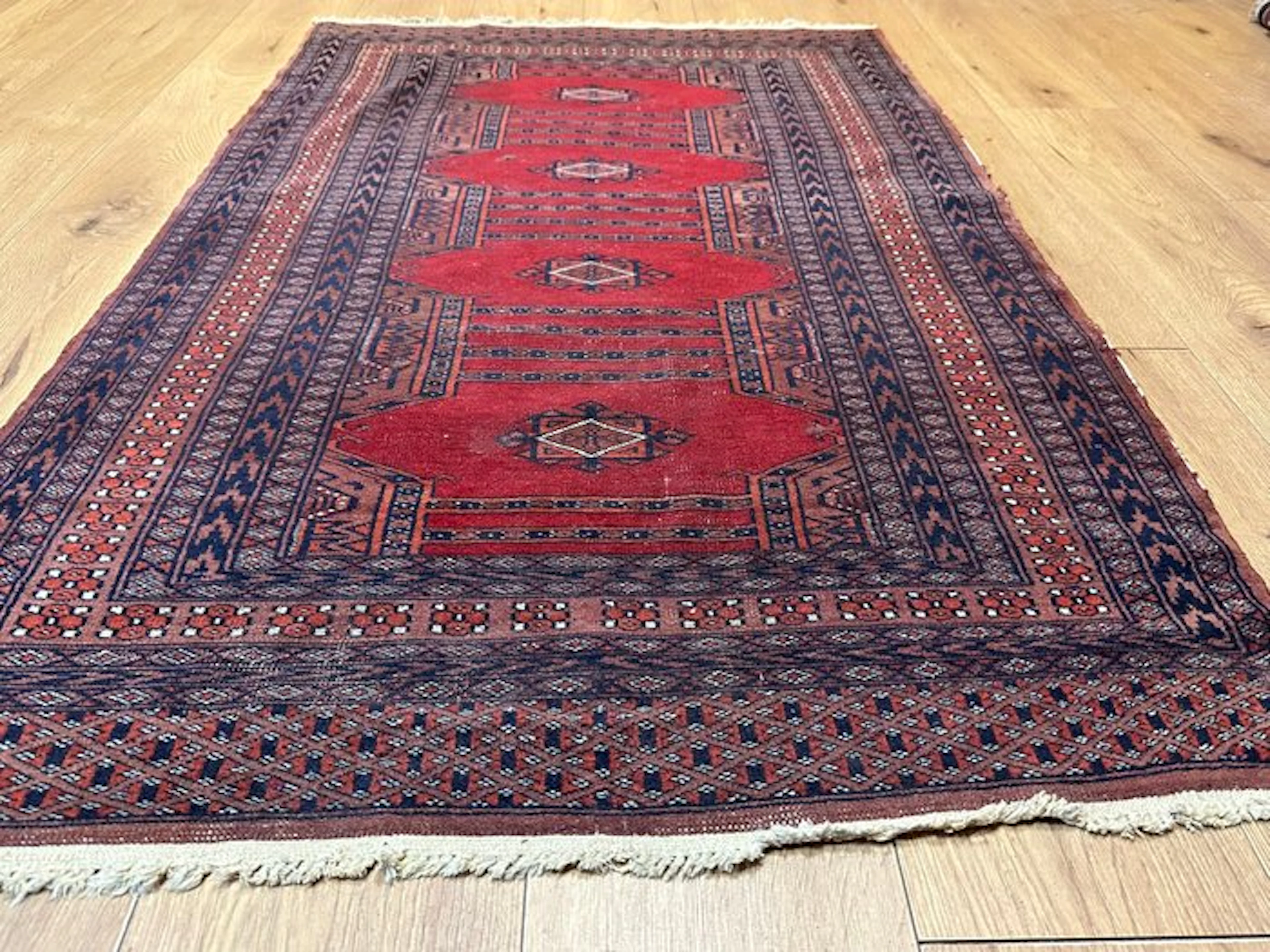 Hand-knotted Pakistani Bukhara rug with a classic Tekke pattern