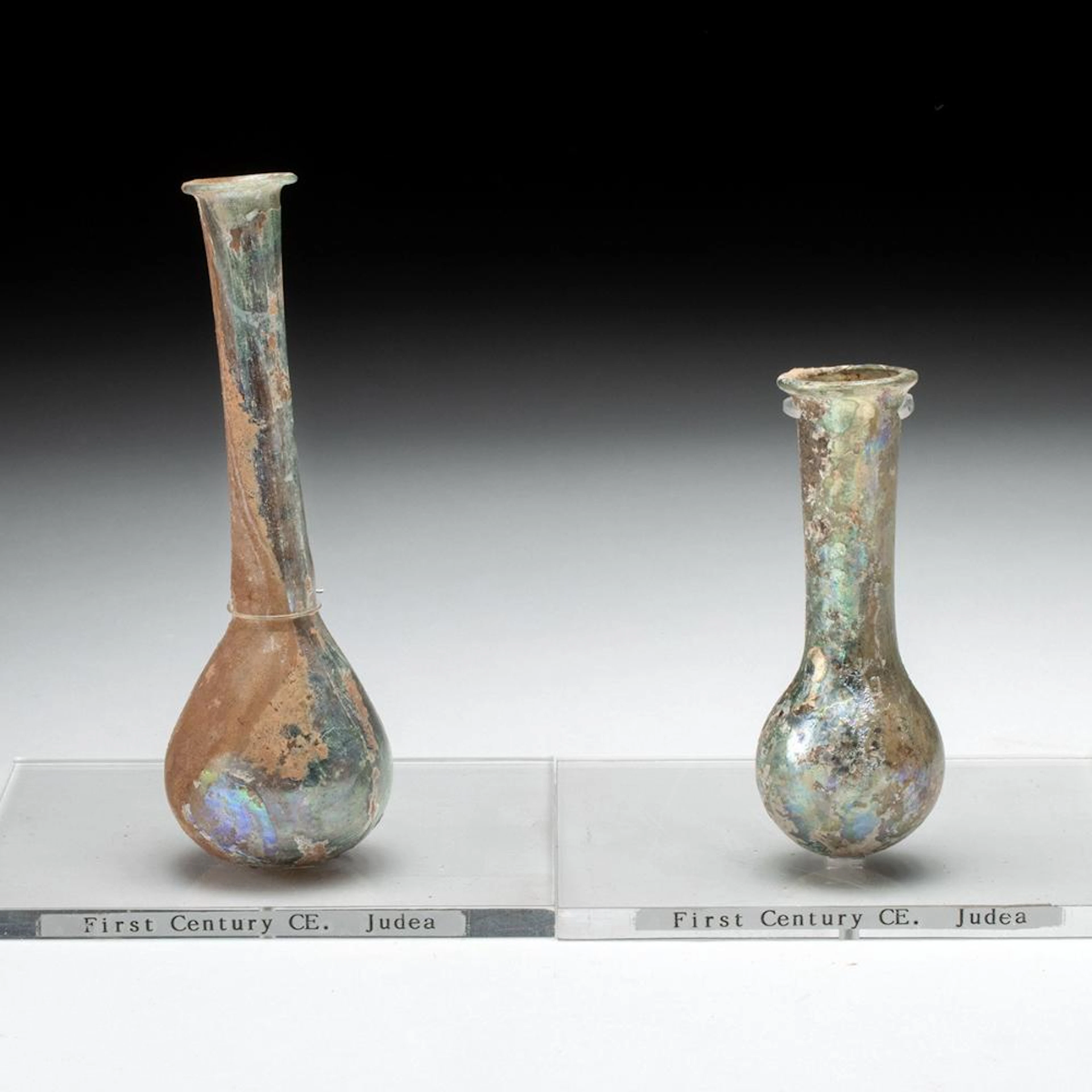 Two Roman Glass Unguentaria with Iridescent Surfaces
