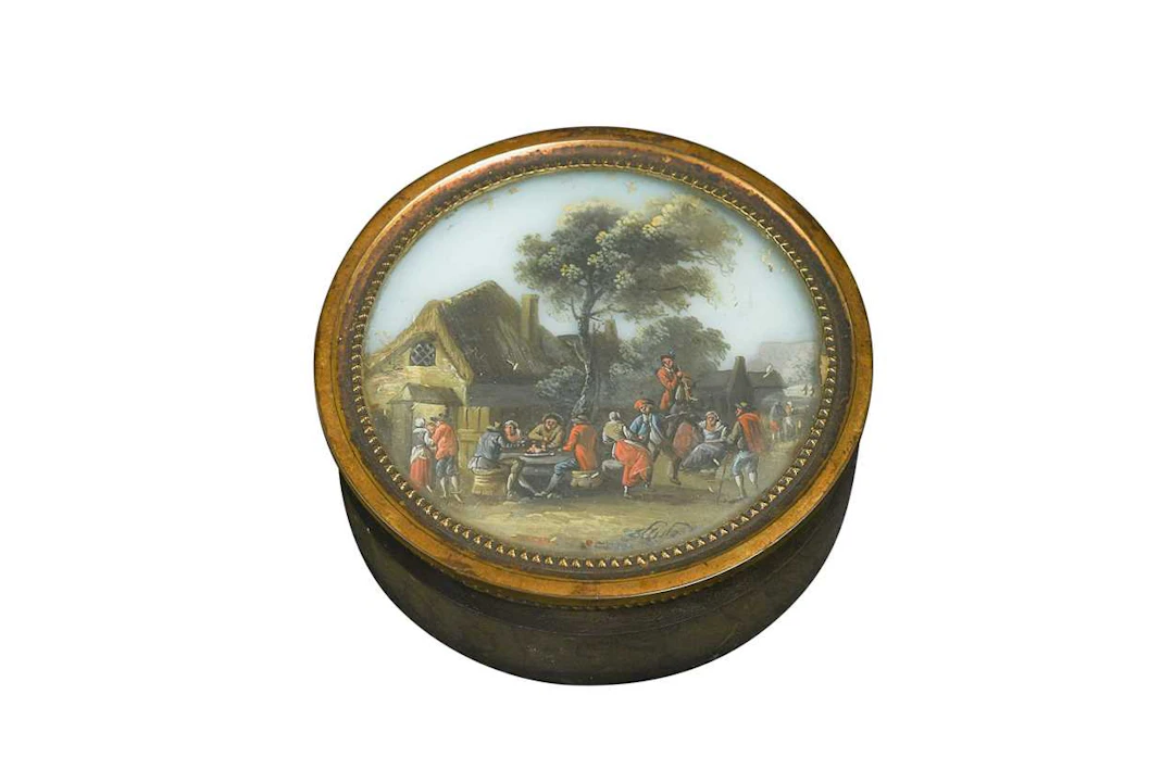 A circular tortoiseshell and gilt-metal mounted snuff box and cover