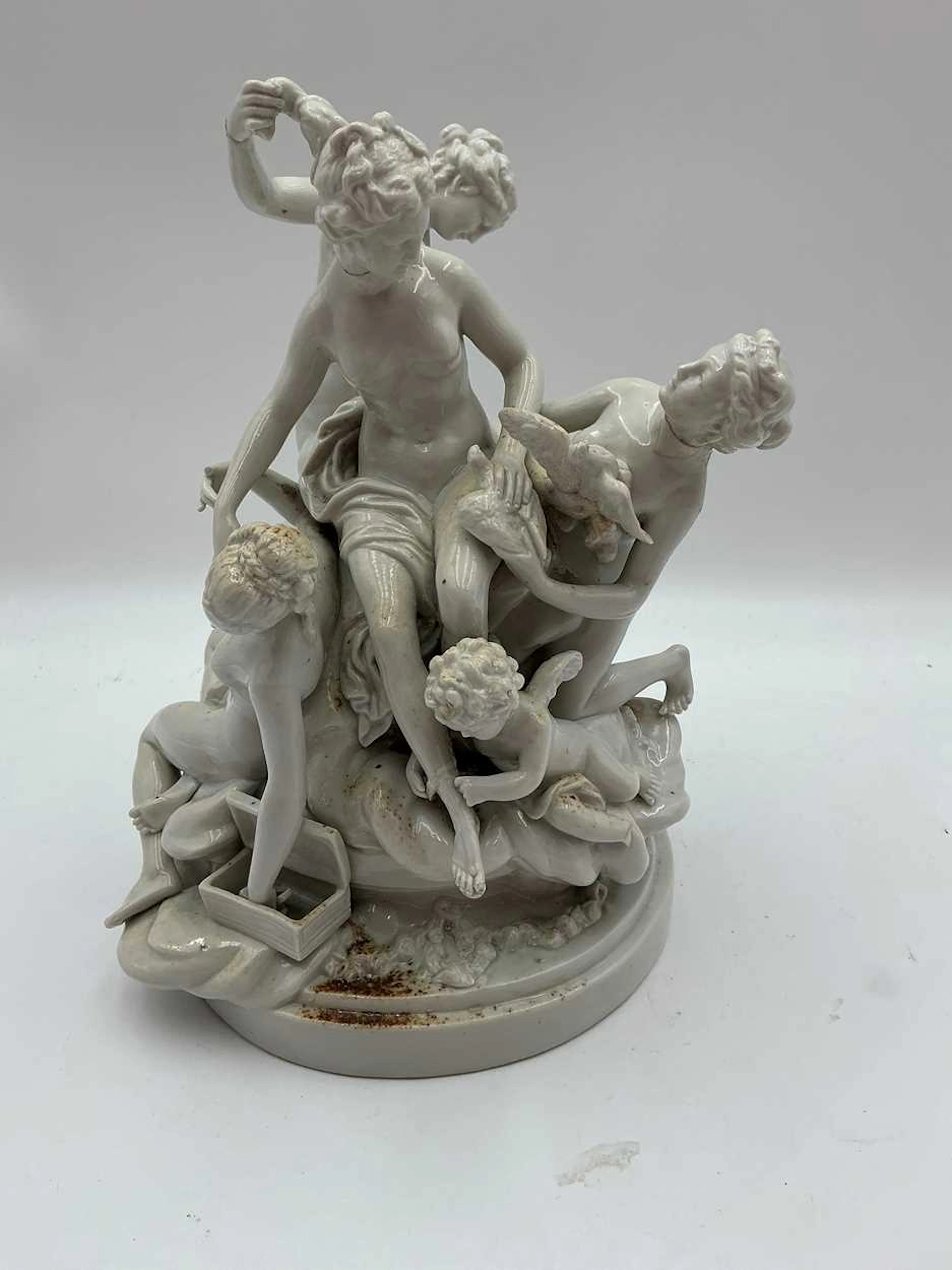 A continental porcelain white glazed figure group of La Toilette de