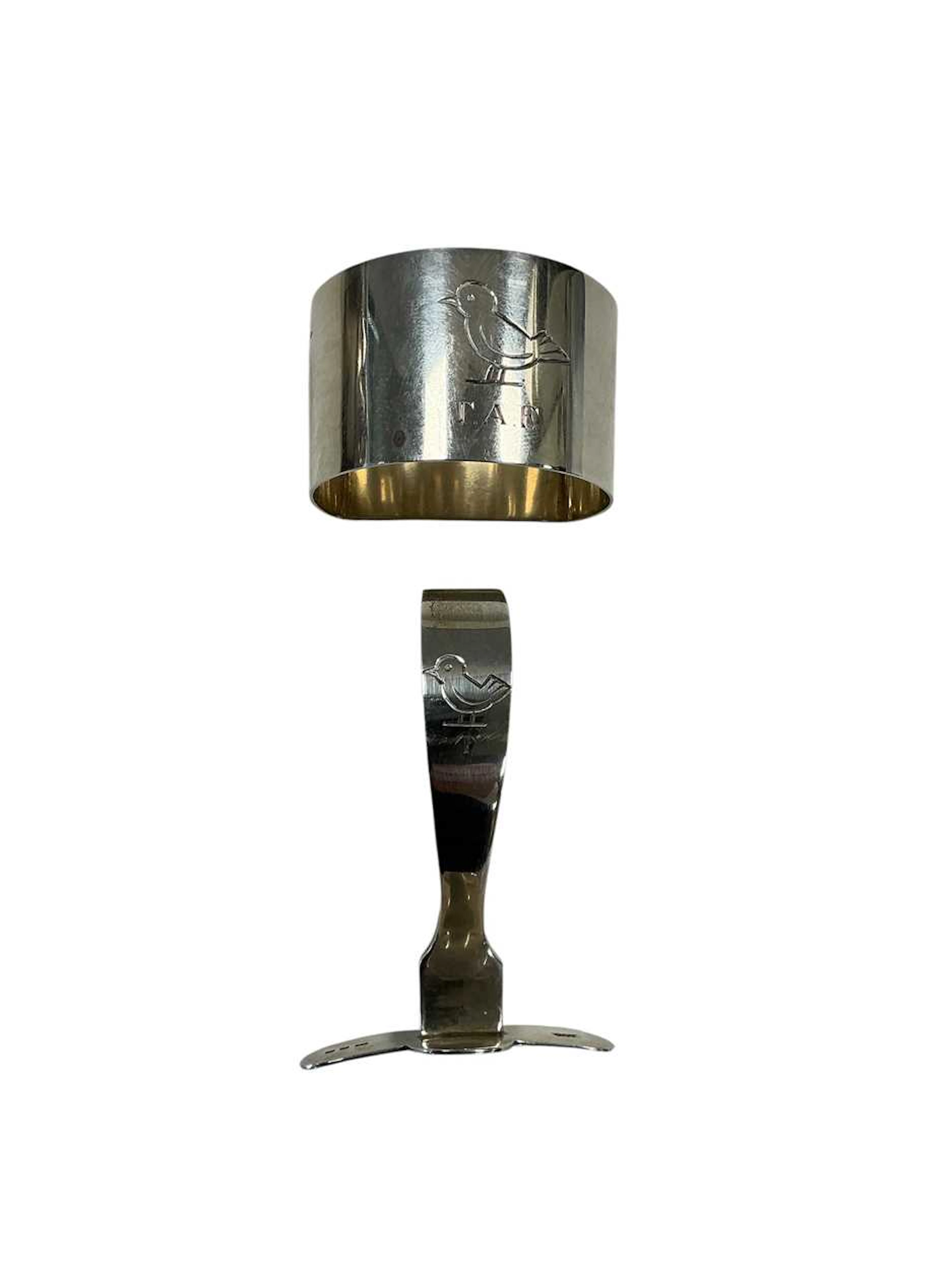 A silver childs feeding spoon and napkin ring engraved with a duck
