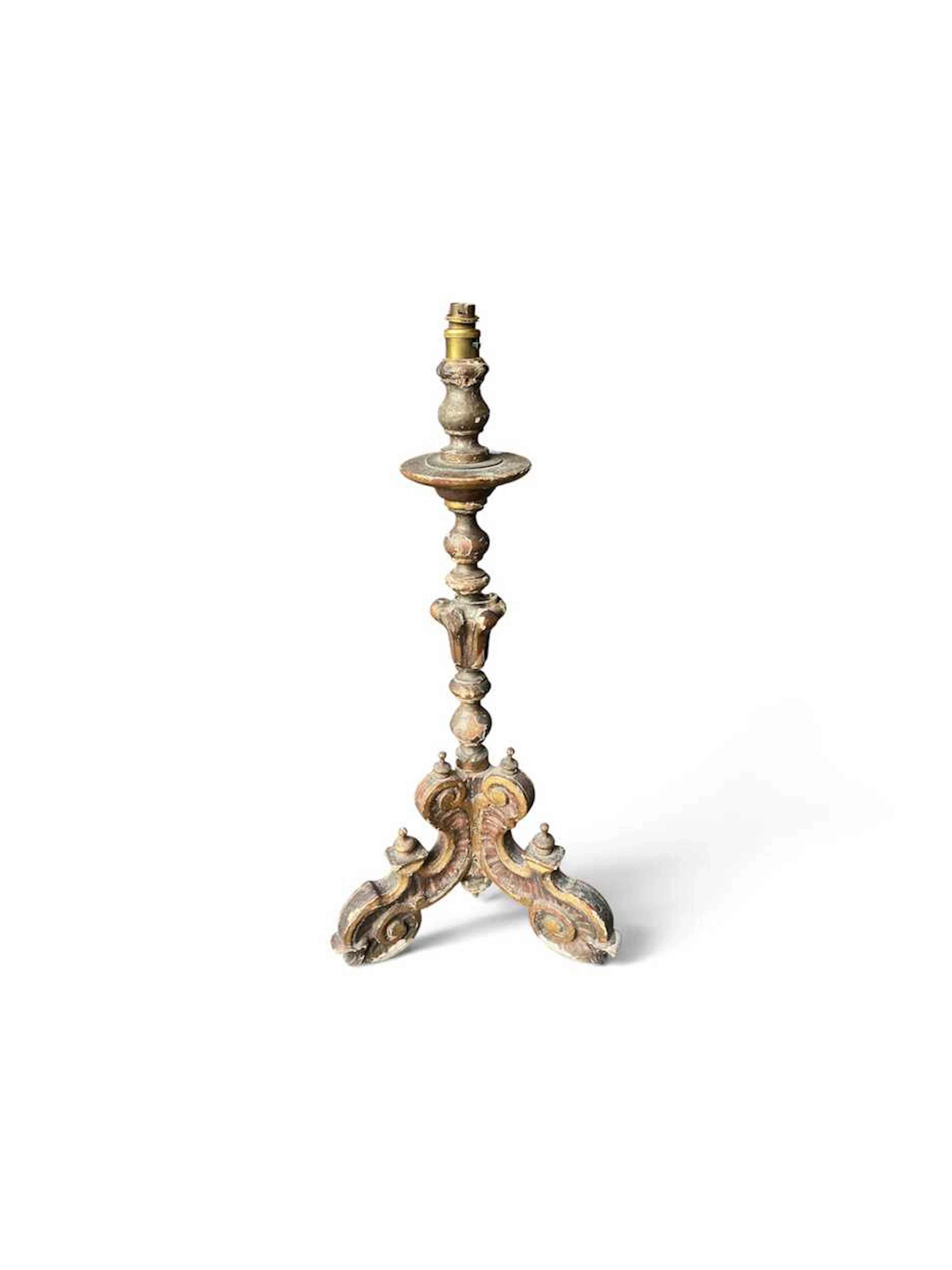 Carved painted and gilded triform candlestand