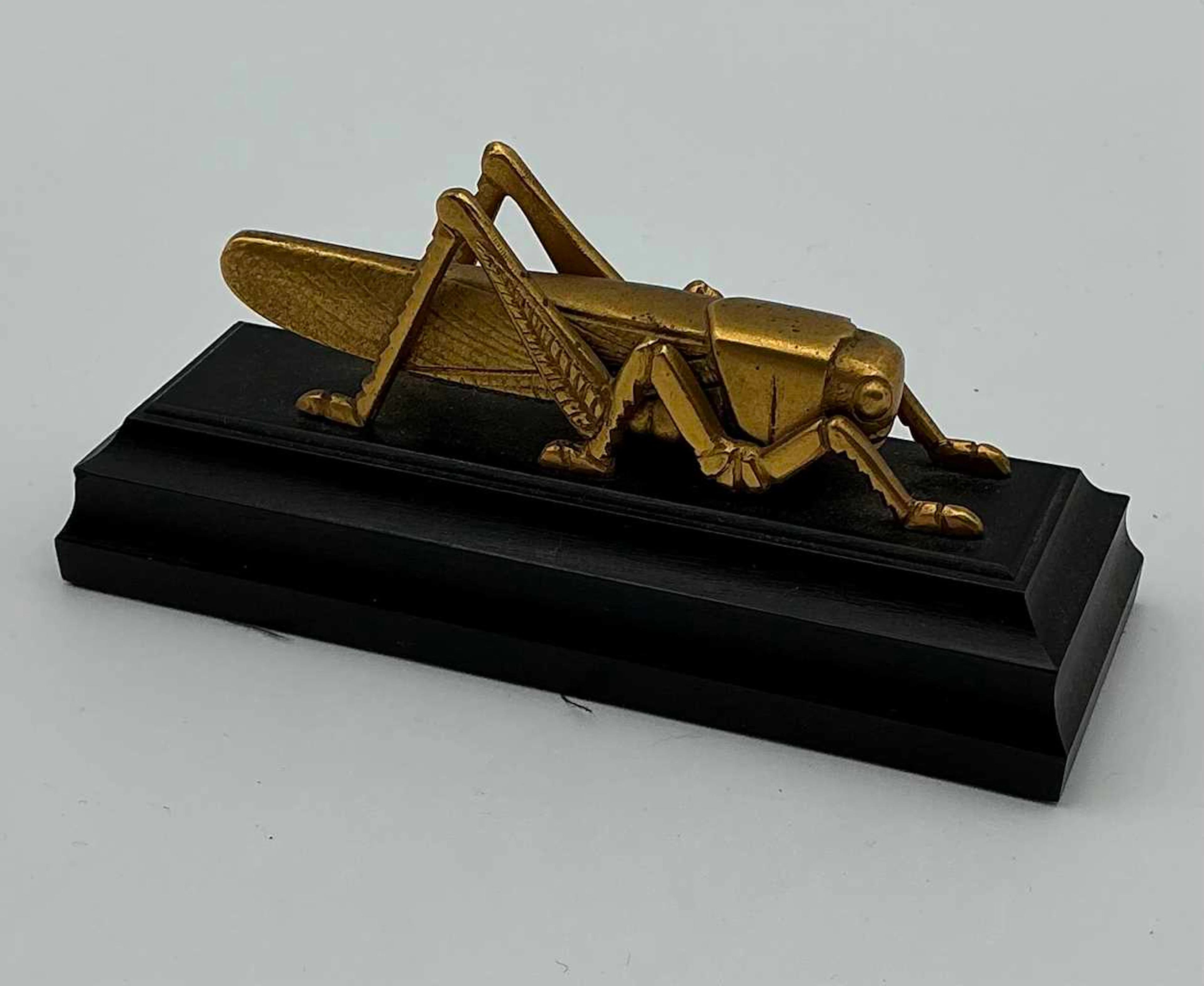 A Martins Bank gilt metal Grasshopper desk ornament...