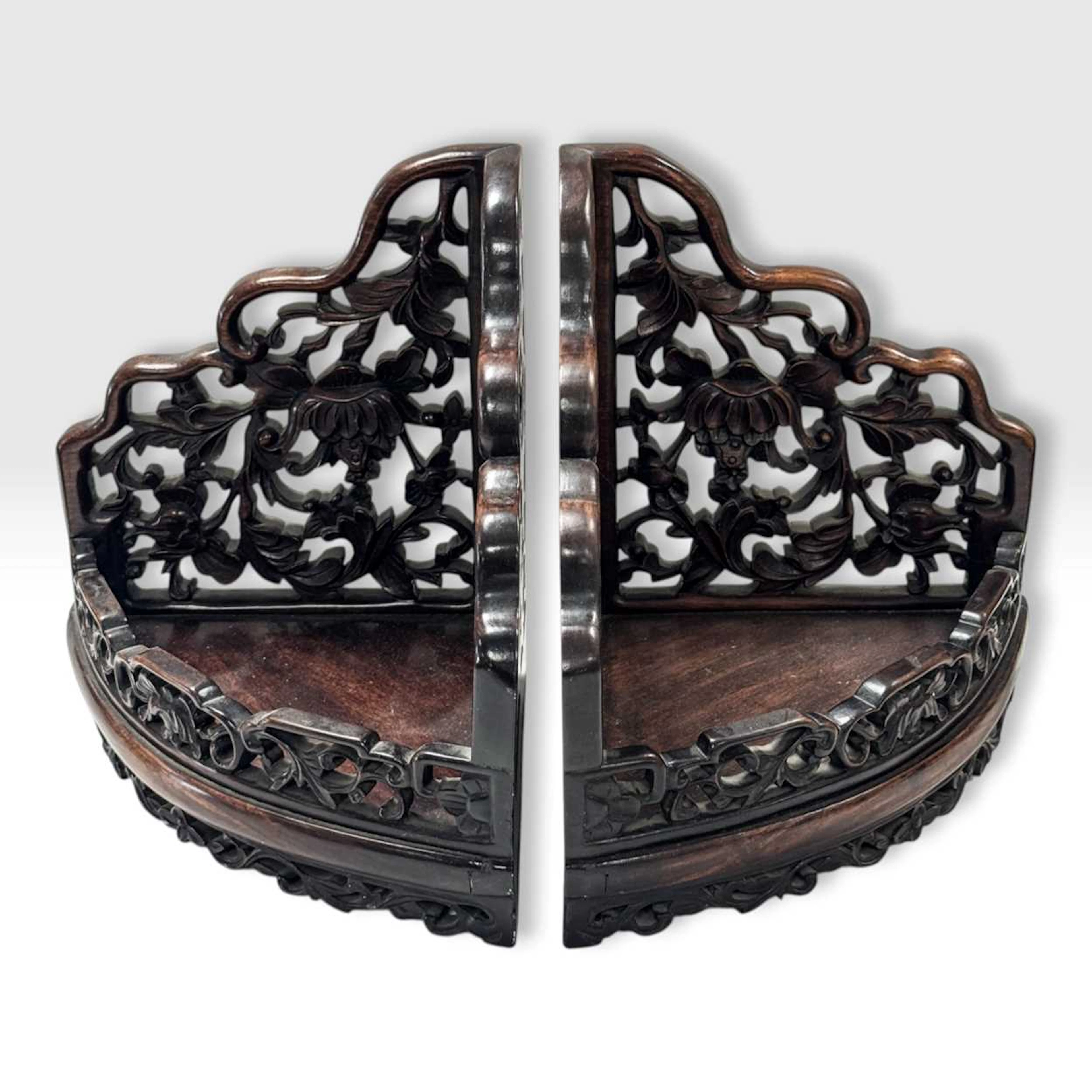 A pair of Chinese carved pierced hardwood corner shelves, circa 1900