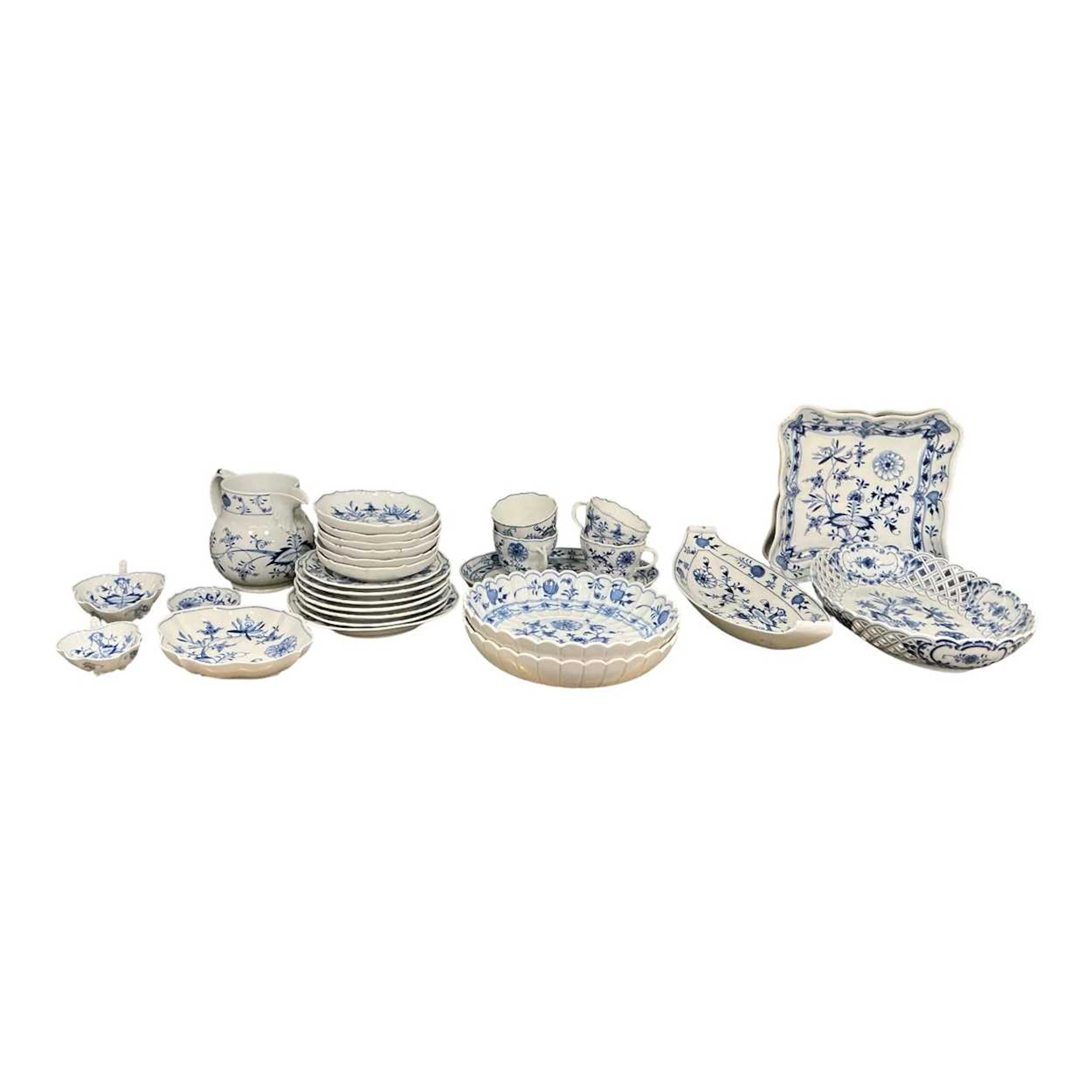 A Meissen onion pattern service comprising four cups and saucers