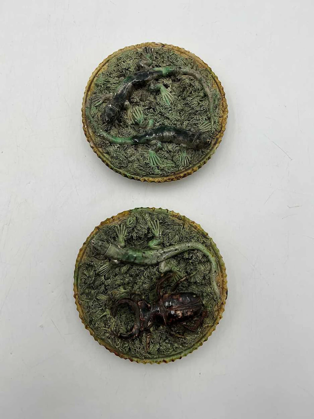 Pair of early 20th century moulded stoneware wall plaques by Caldas