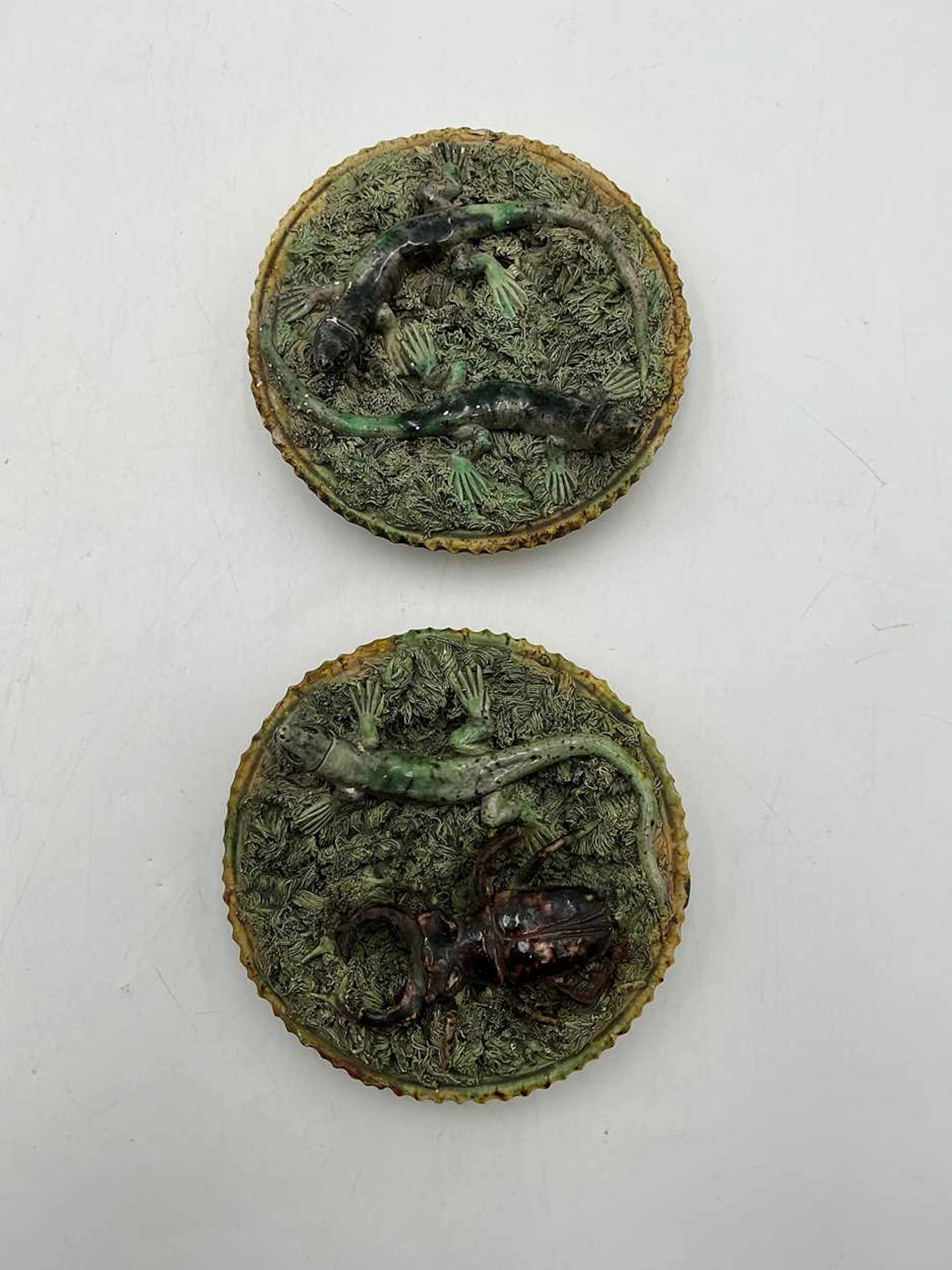 Pair of early 20th century moulded stoneware wall plaques by Caldas