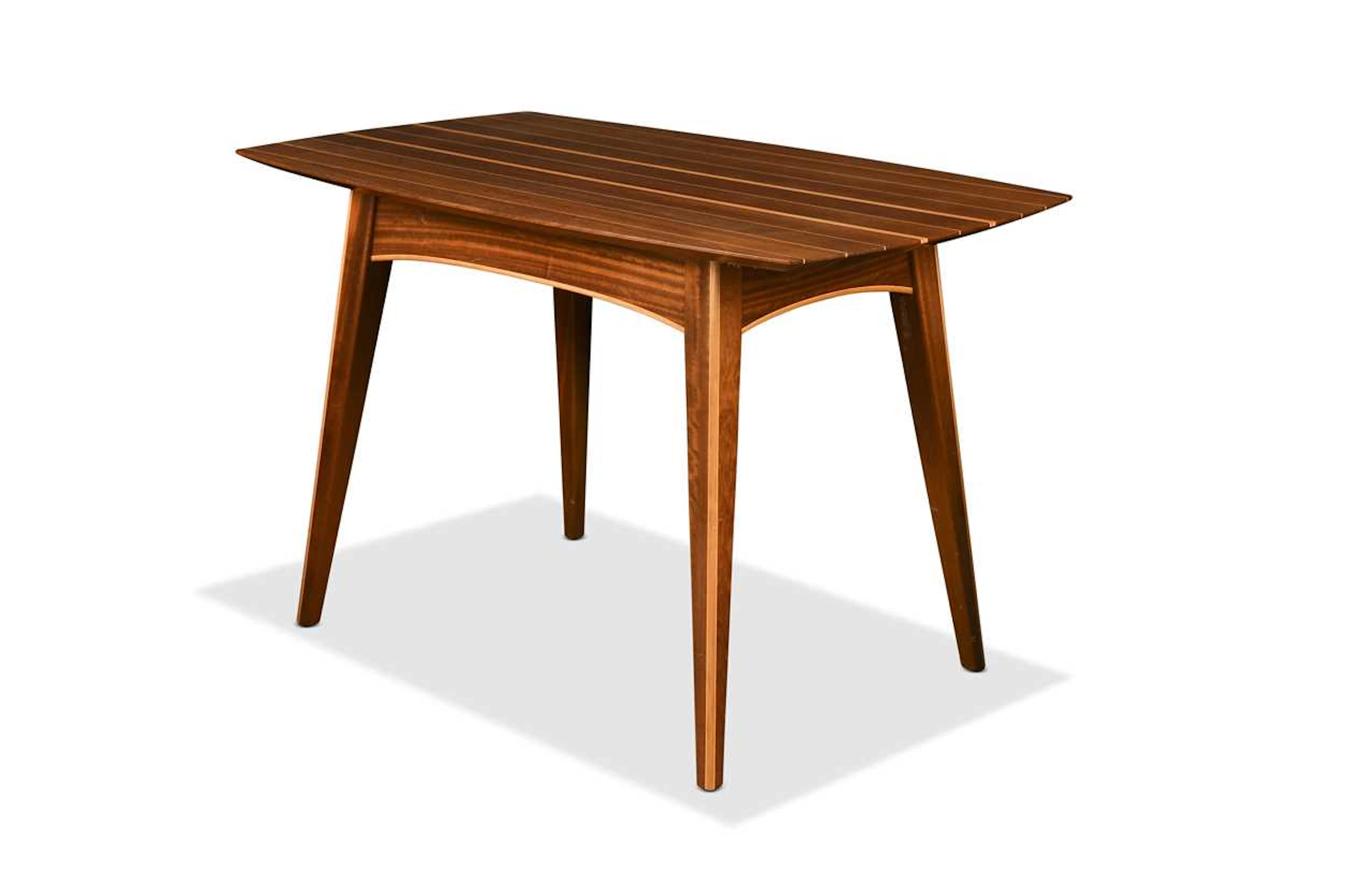 A contemporary bespoke made walnut dining table