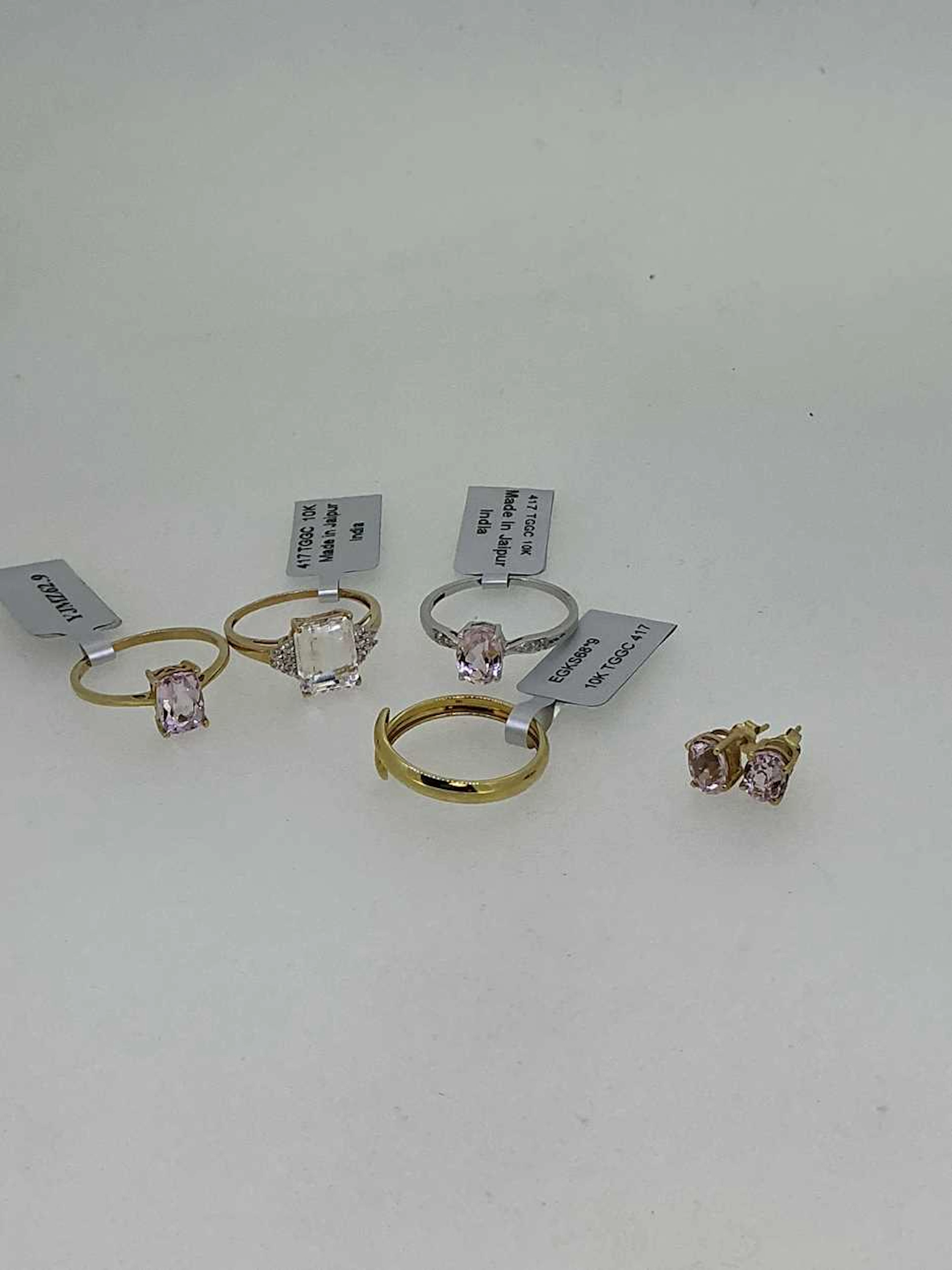A collection of three hallmarked 9ct gold kunzite rings